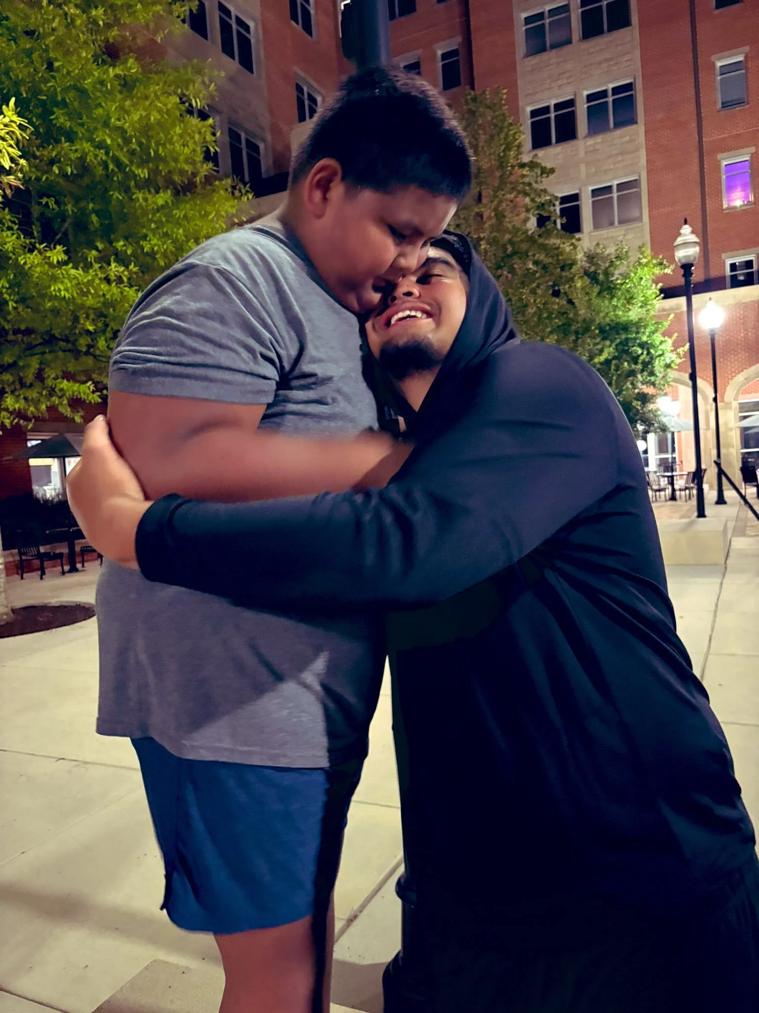 Antoni and Troy Ogumoro embrace during their visit at Stokley Hall