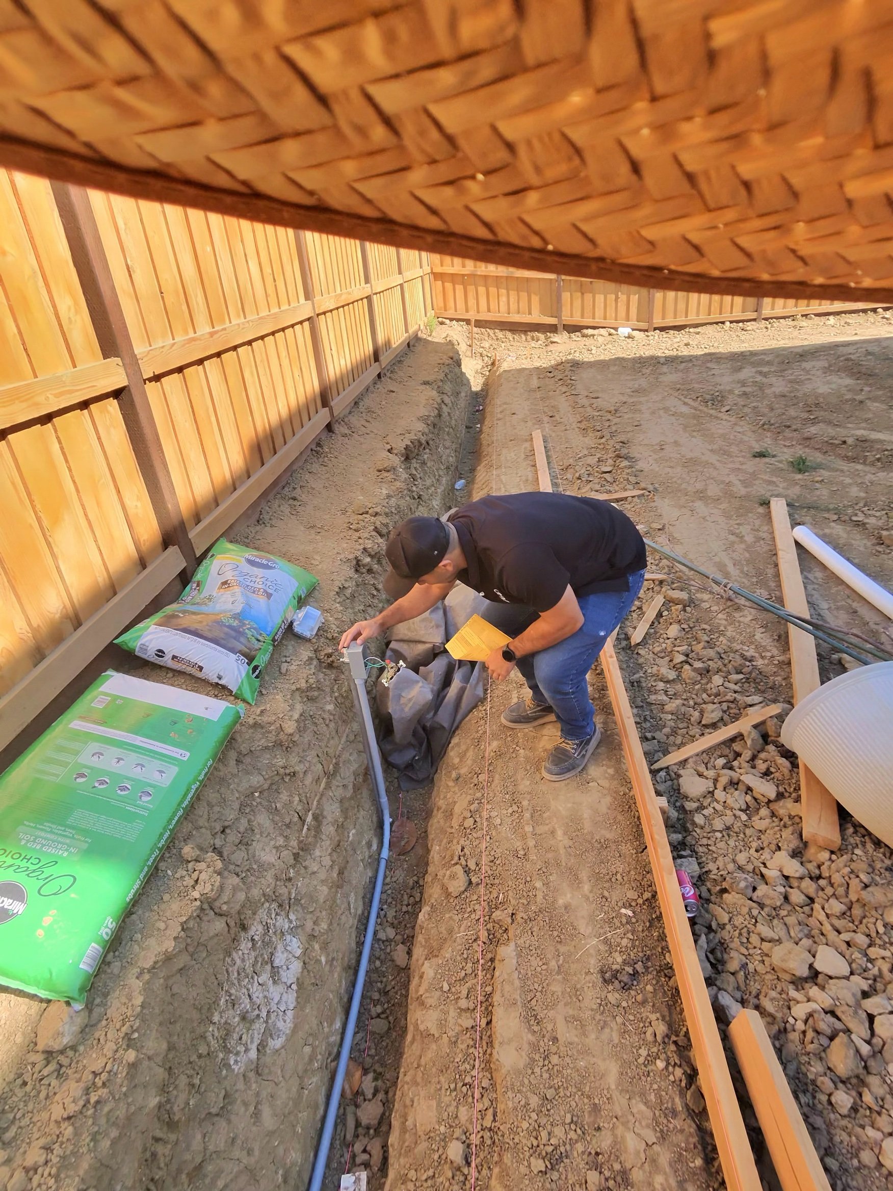 Conduit run in an open trench for backyard outlets in Mountain House by MH Electrical Services.