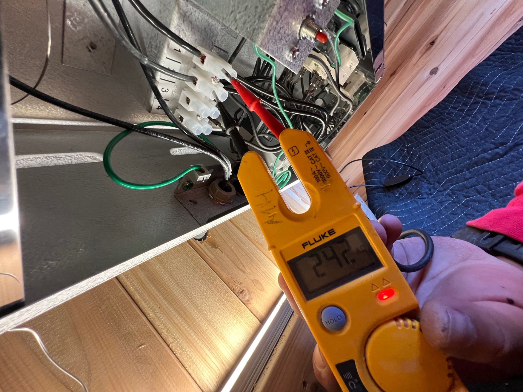 Voltage test at a backyard sauna in Brentwood by MH Electrical Services.