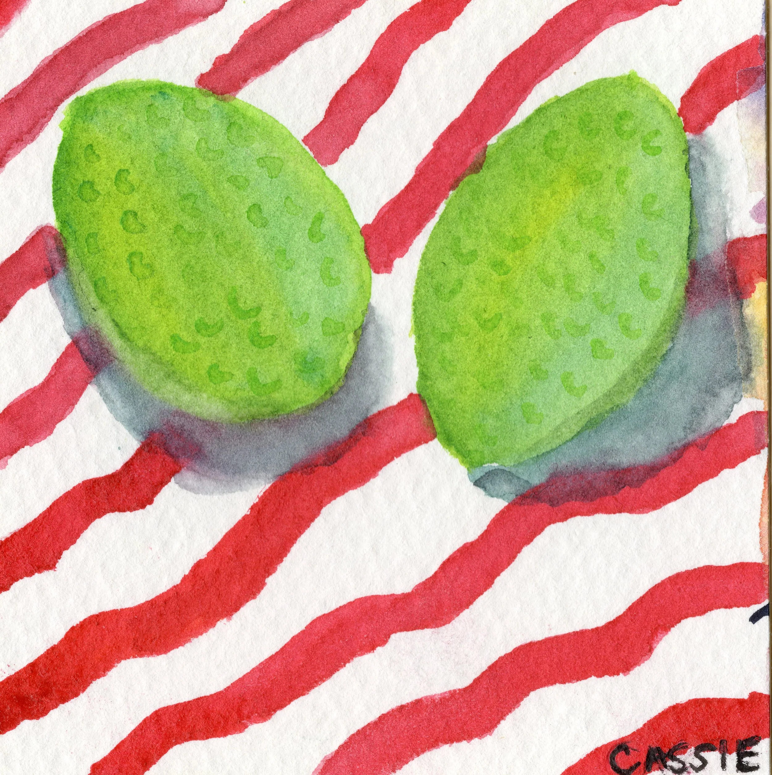 Close-up view of a hand-painted American flag with red and white stripes and green circular shapes in the foreground, and part of the word 'CASSIE' visible in black text.