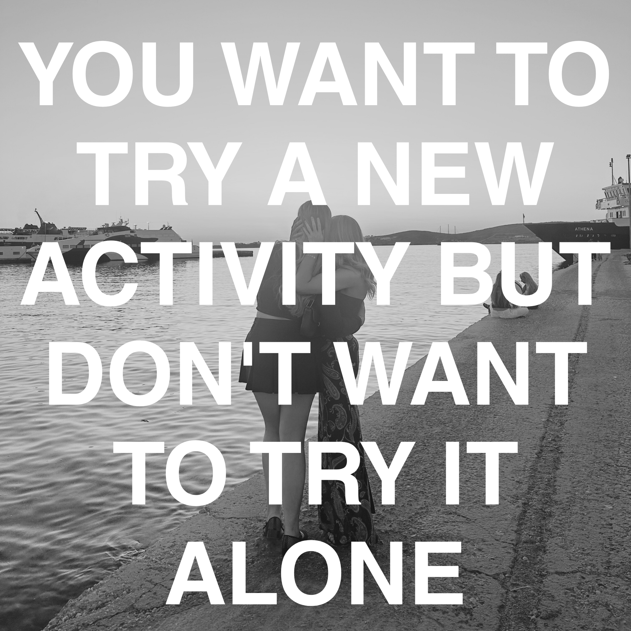 Two people hugging on a waterfront with boats docked in the background, overlaid with the text 'You want to try a new activity but don't want to try it alone'.