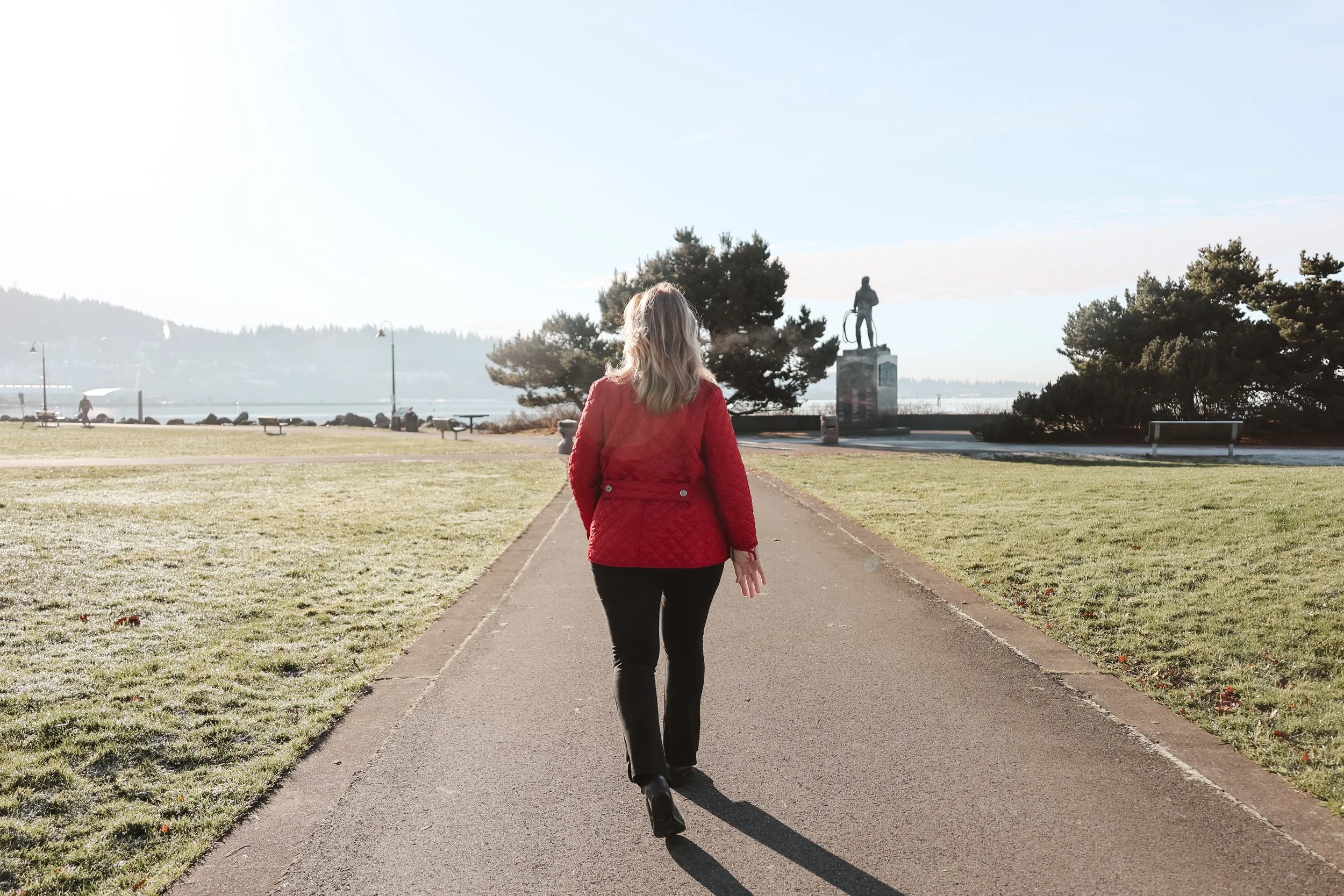 Barbara Jenks of Clearly Communicate walking in Bellingham WA park — personal branding shoot by NYLEAR