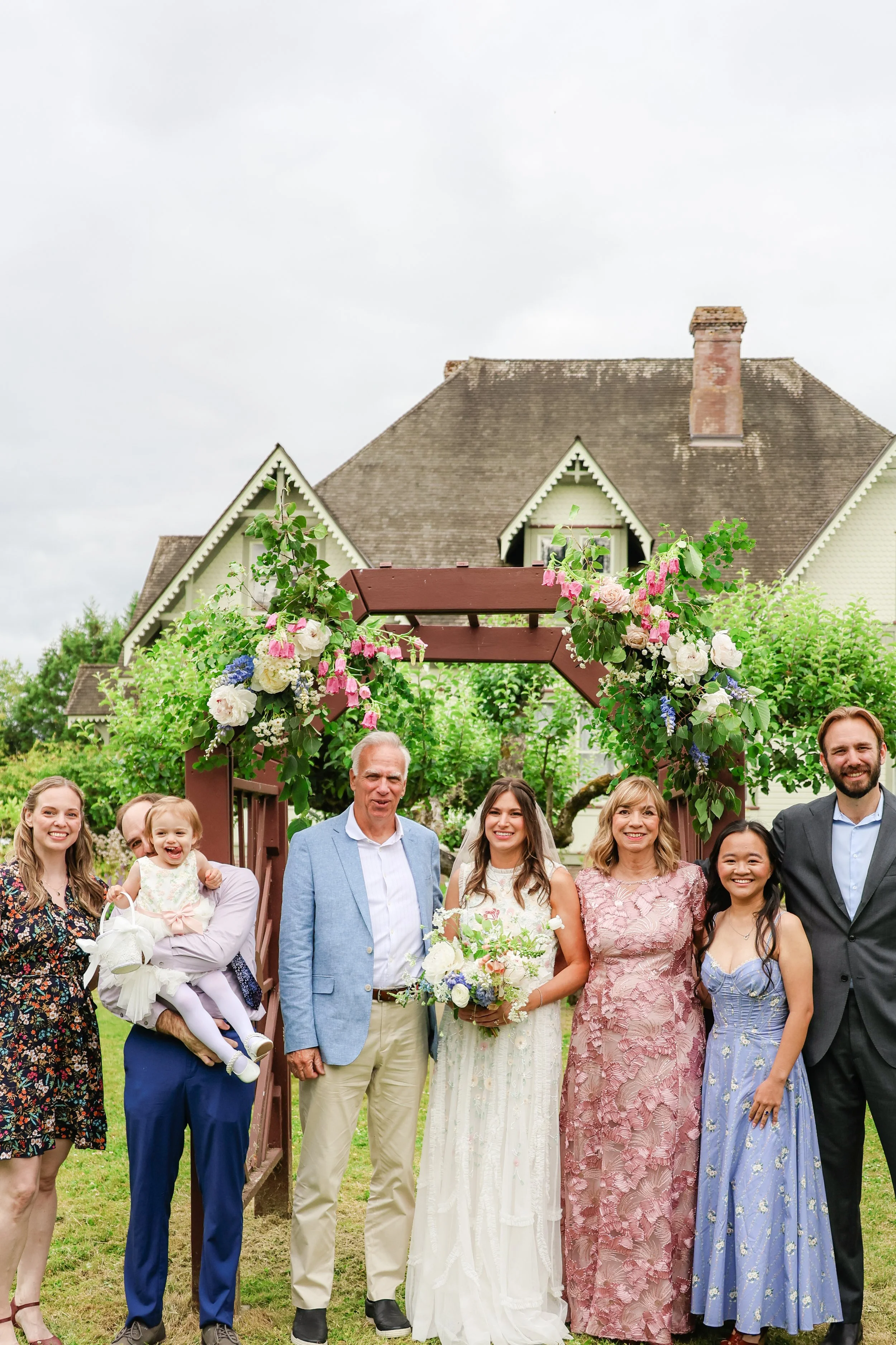 Pacific Northwest wedding party at flower arch — NYLEAR wedding photography serving Bellingham WA and surrounding areas