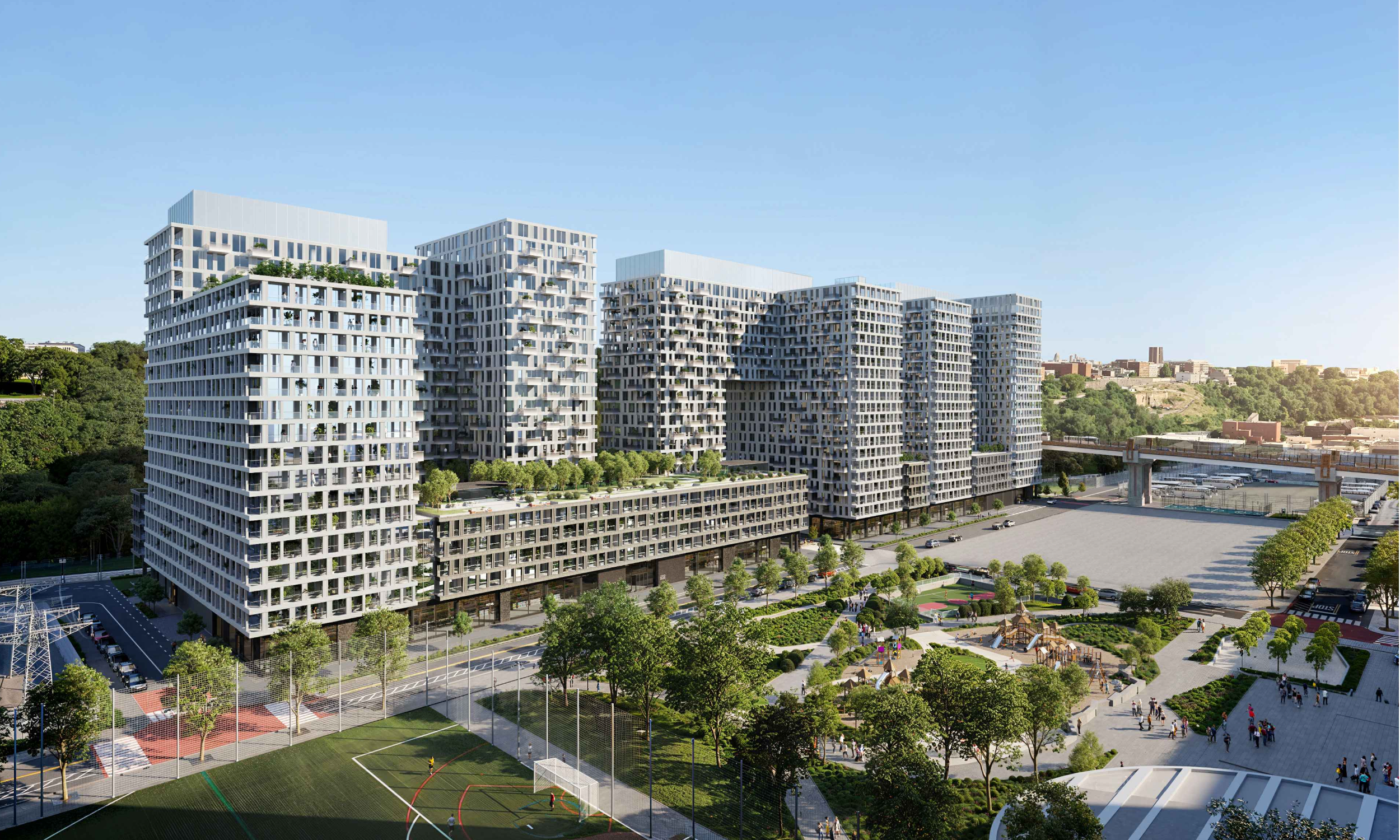 Modern high-rise residential buildings with greenery and rooftop gardens, surrounded by a park, sports field, and people walking.