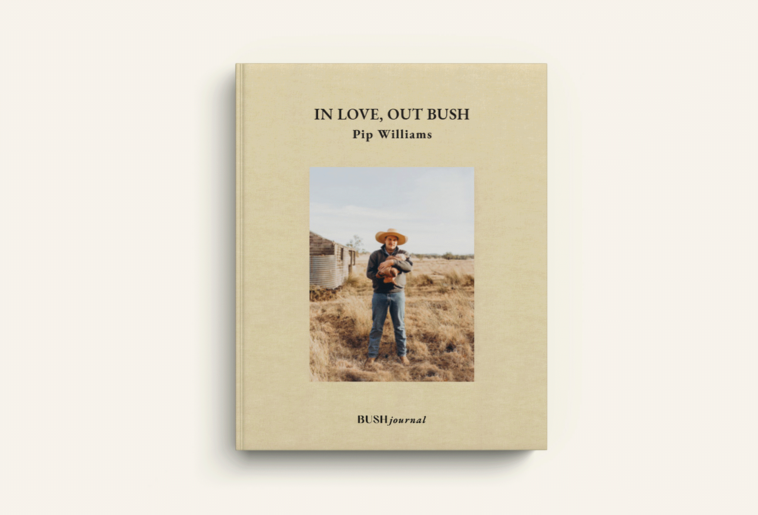 A beige journal titled 'In Love, Out Bush' by Pip Williams with a photo of a woman wearing a wide-brimmed hat holding a dog in a rural dry landscape on the cover.