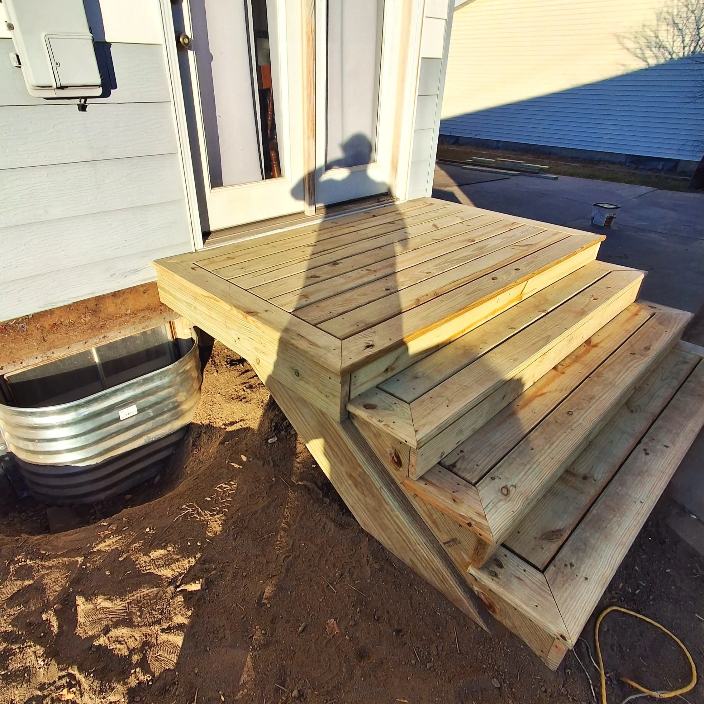 custom exterior wood deck and stairs with detailed picture frame trim by Zilkoski Construction LLC
