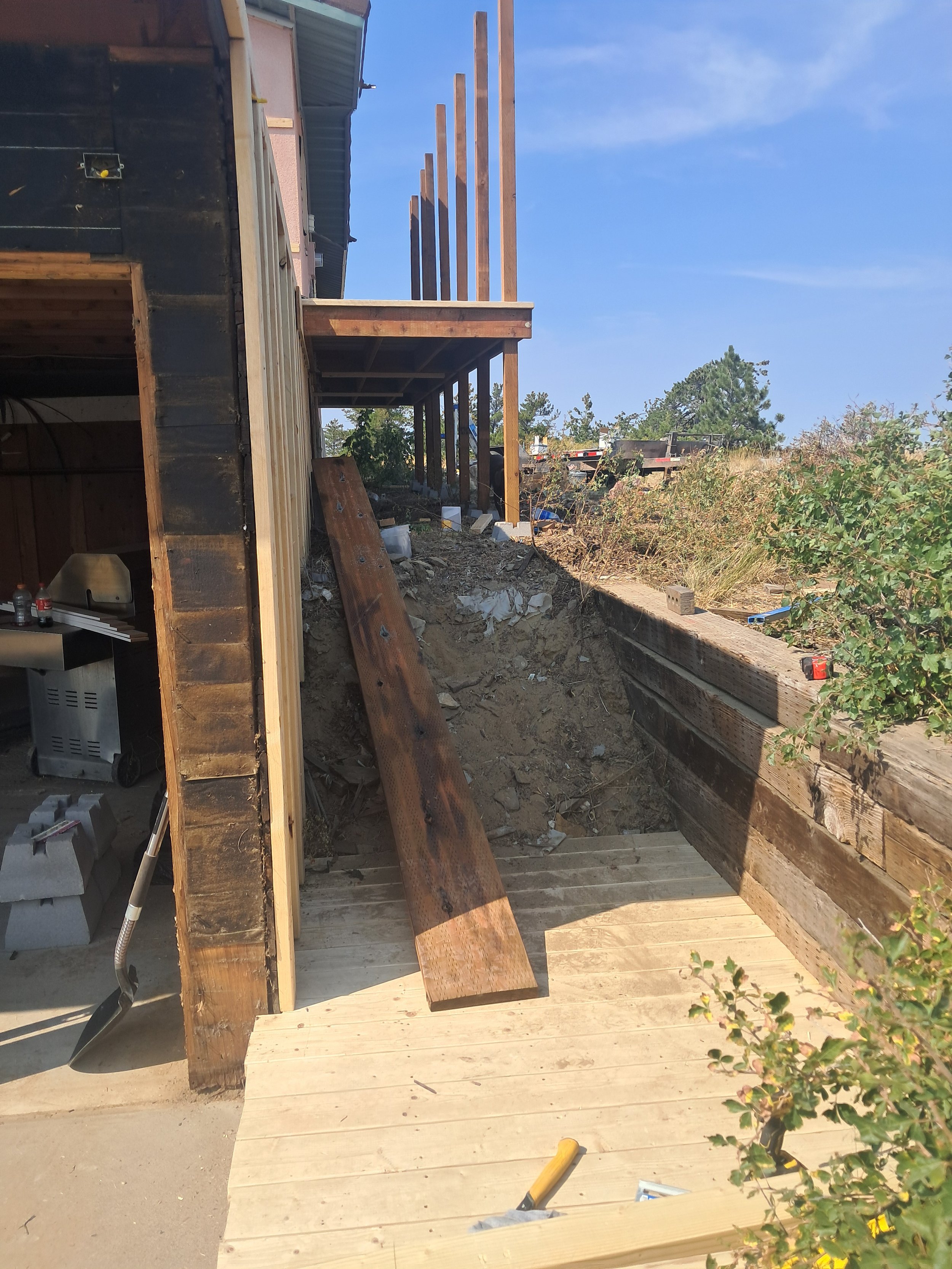 Deck framing and post installation on a sloped site.