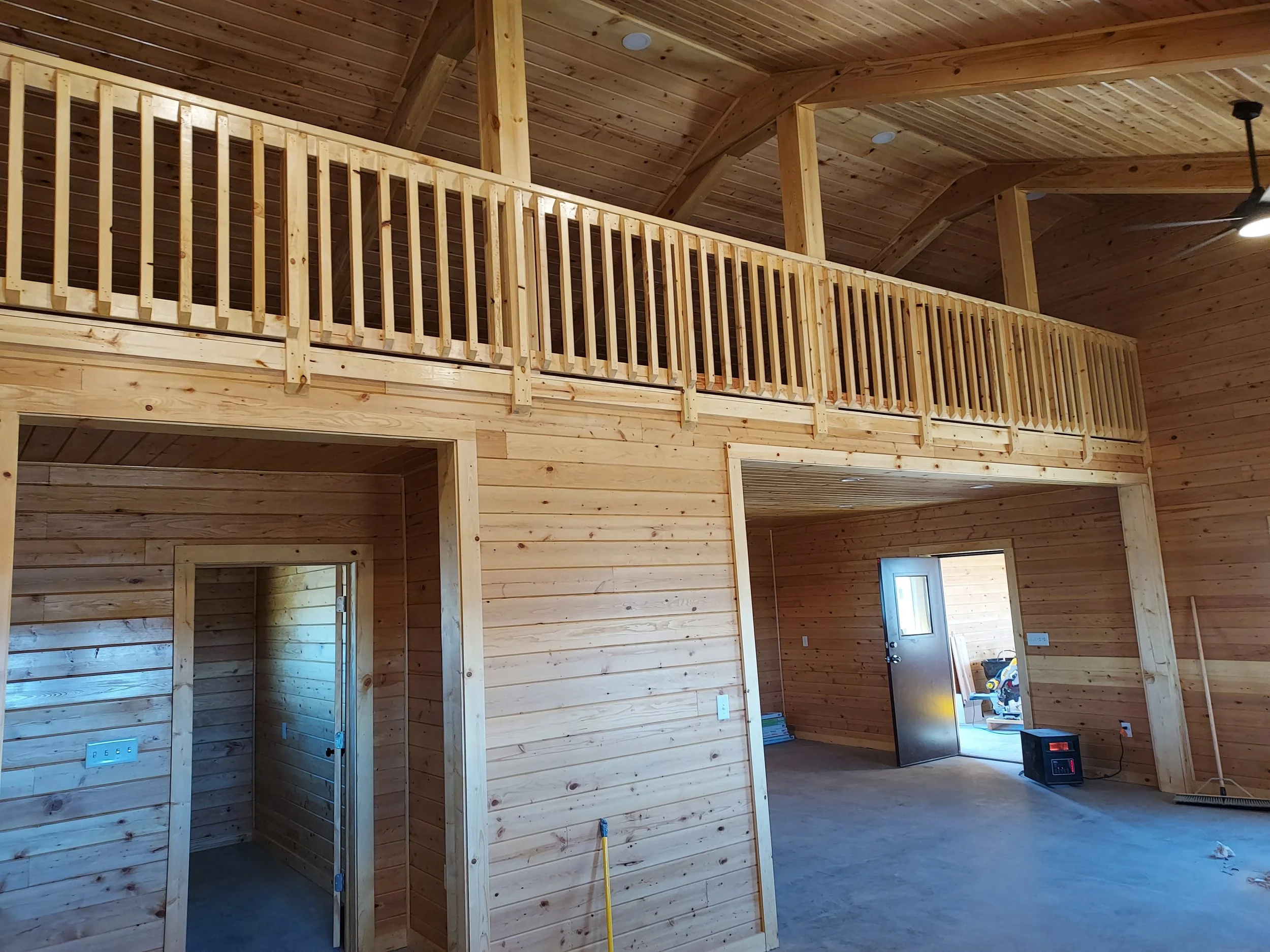 custom all-wood tongue and groove wood interior with loft and railing construction.