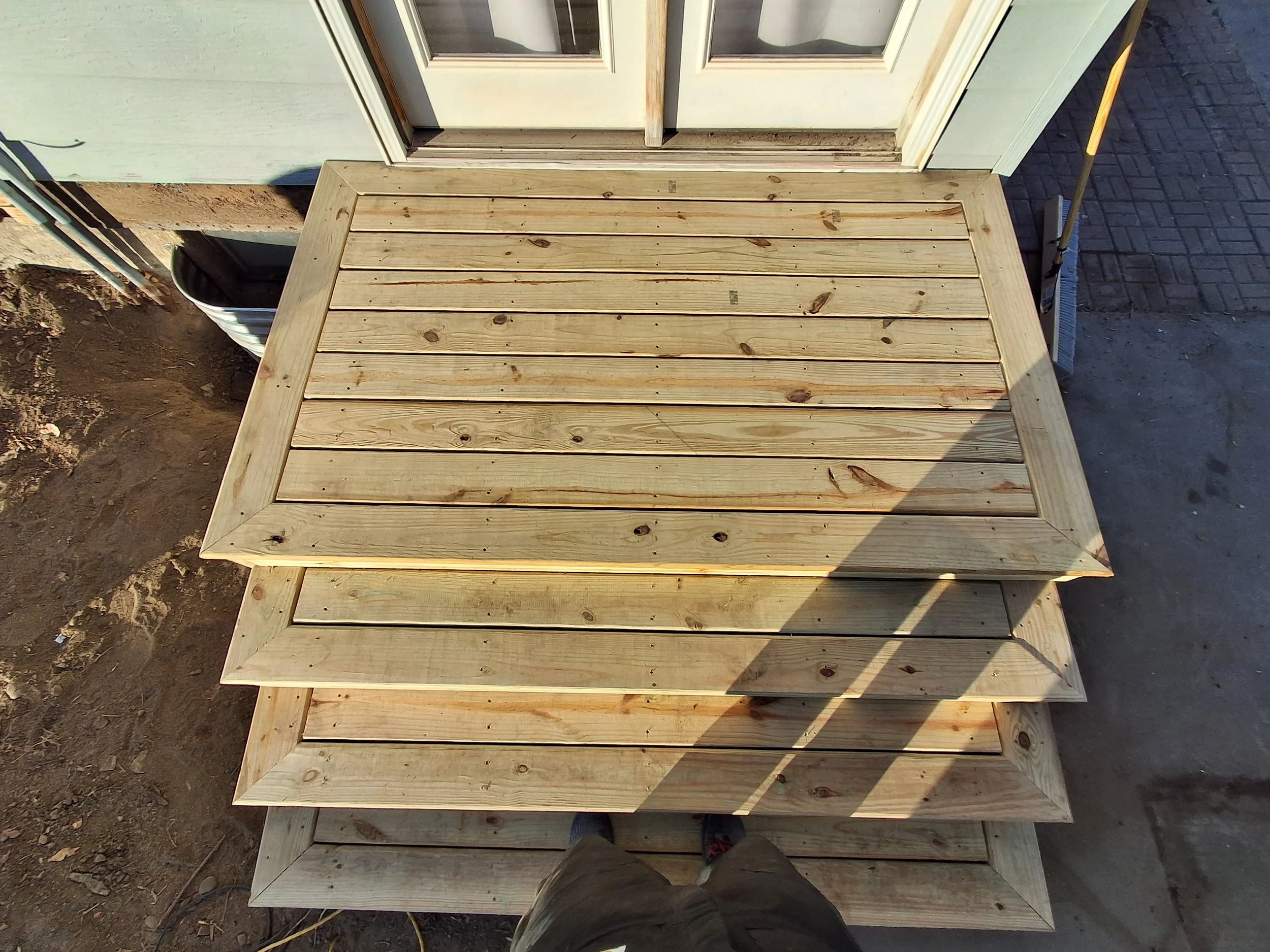 Exterior deck and stair construction with picture-frame detailing by Zilkoski Construction LLC. 