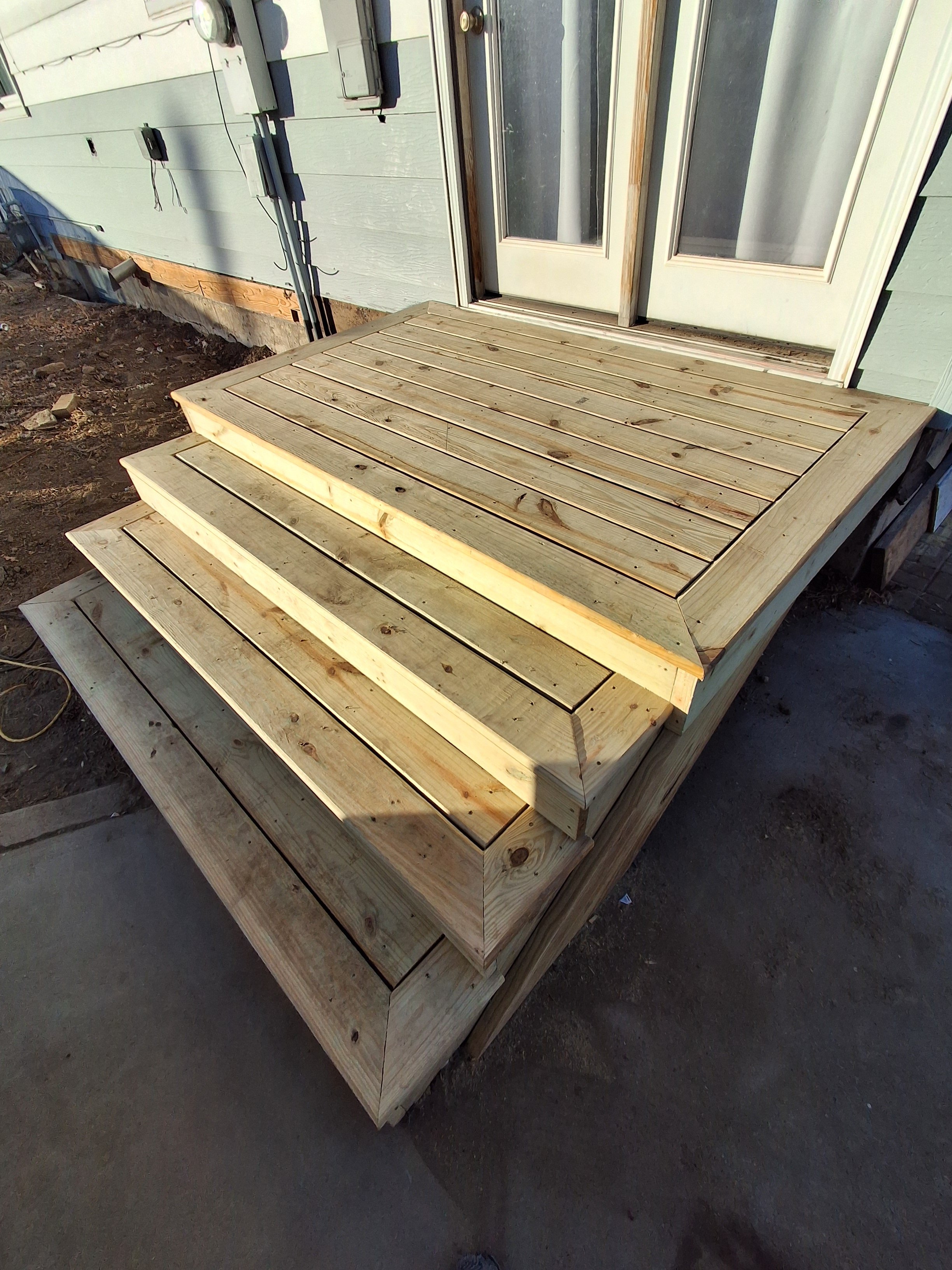 Custom exterior wood deck and stairs with picture frame trim work by Zilkoski Construction LLC. 