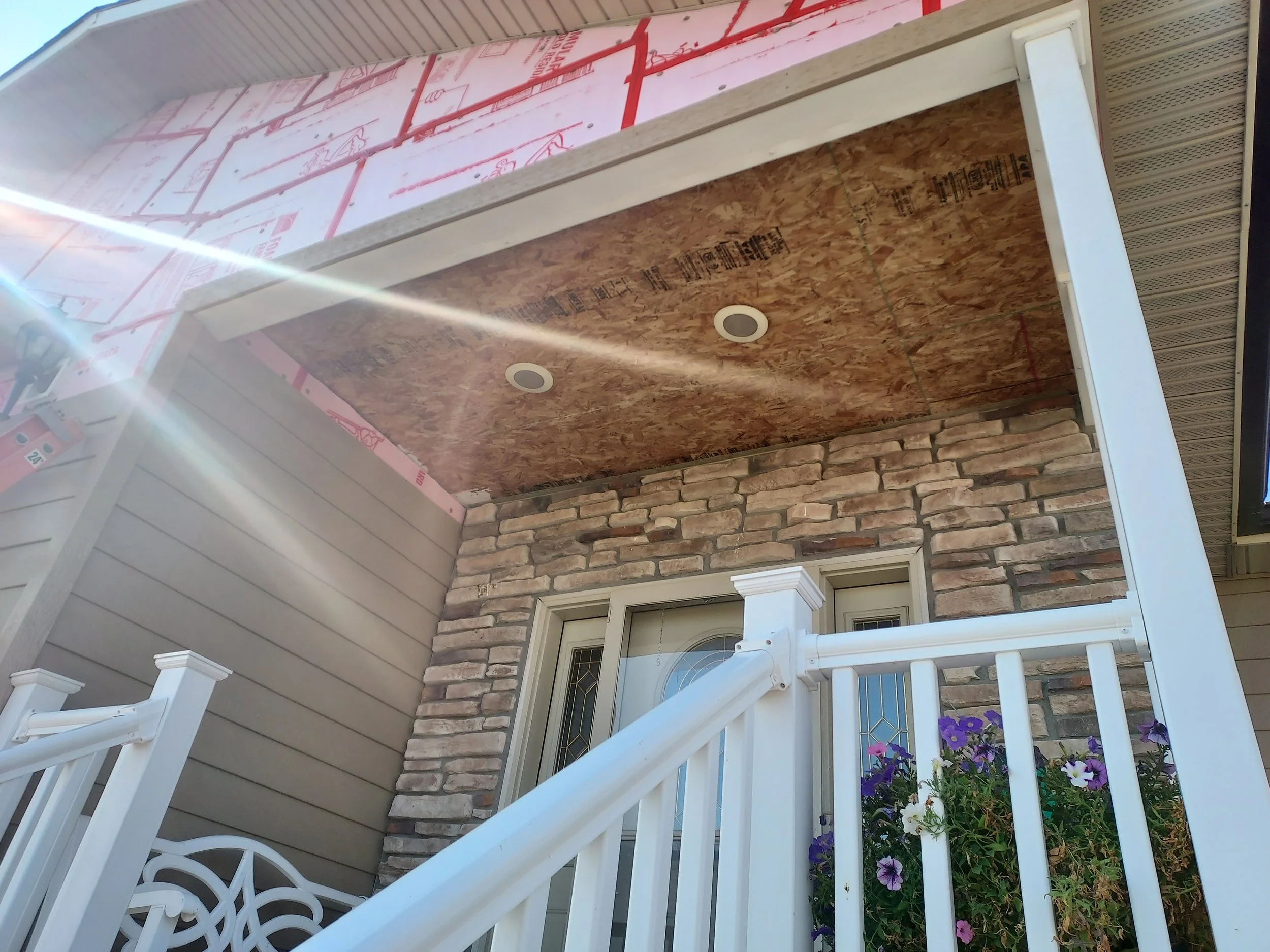 Front porch soffit lighting and ceiling replacement under construction. 