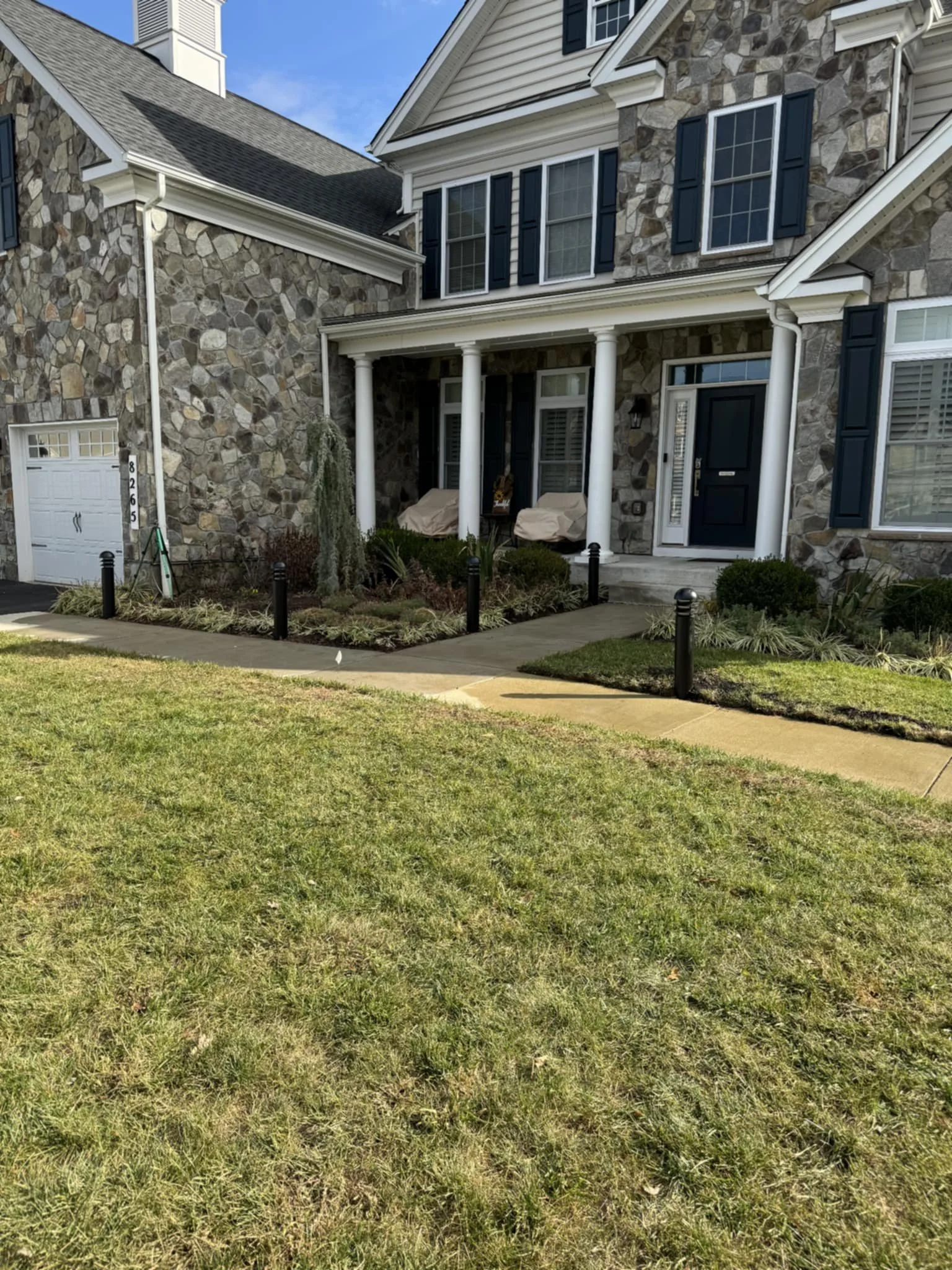 Luxury home with new landscape lighting installed along front walkway.