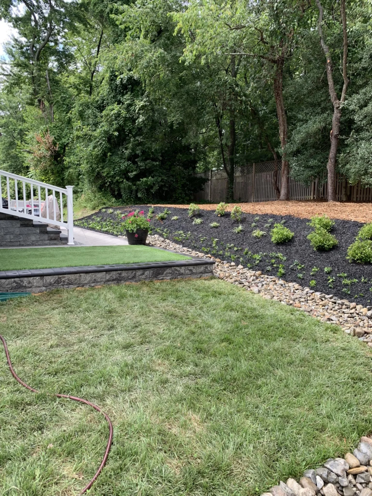 Landscape bed with mulch and stone drsainage installed along with fresh sod.