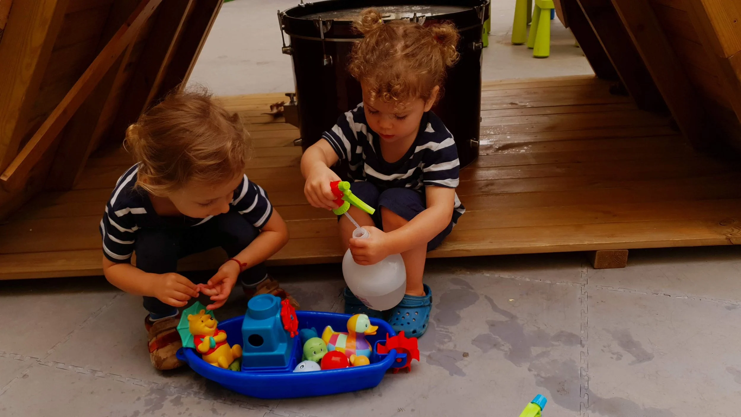 Two kids playing in a wooden house