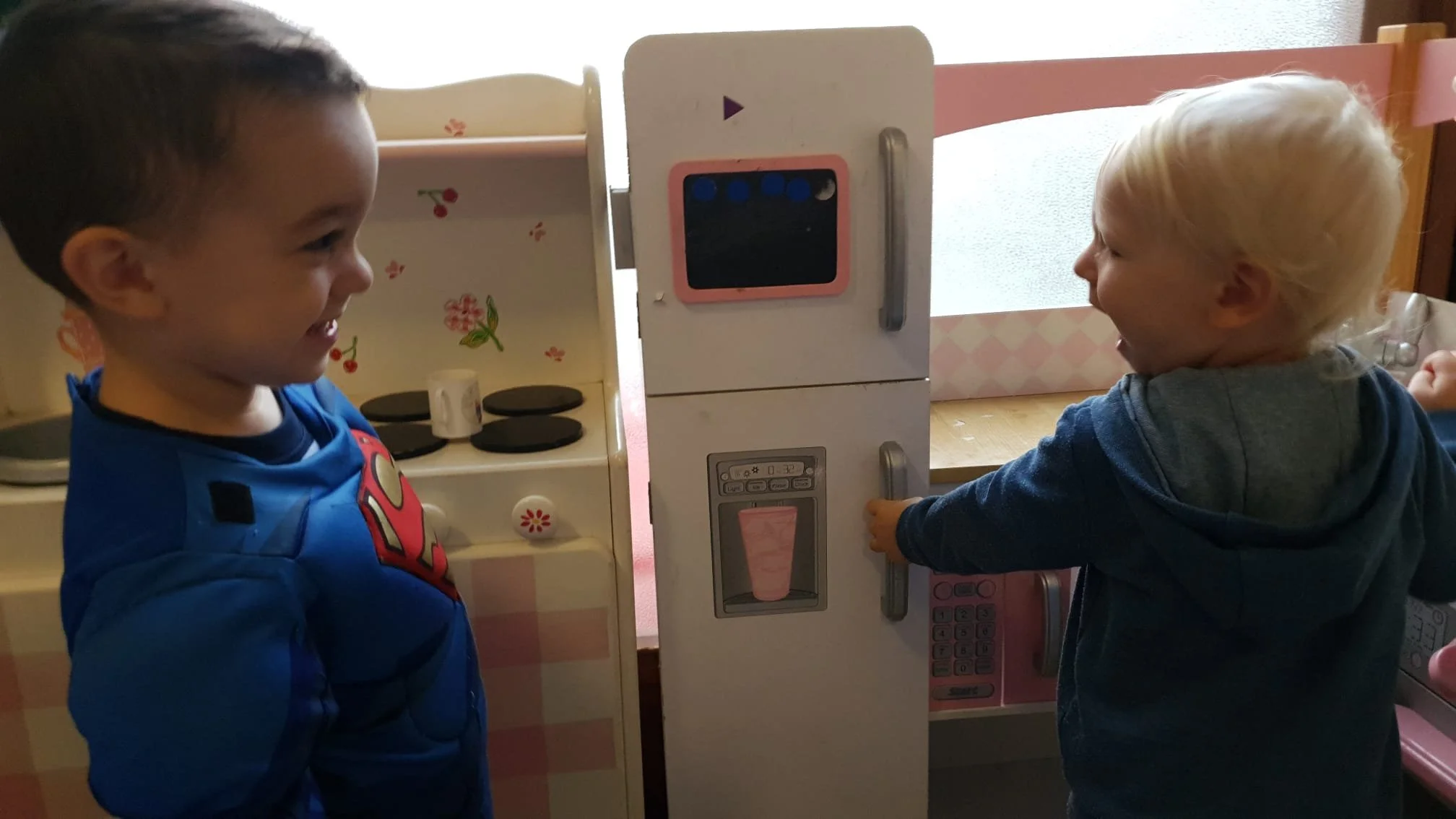 Playing in a toy kitchen