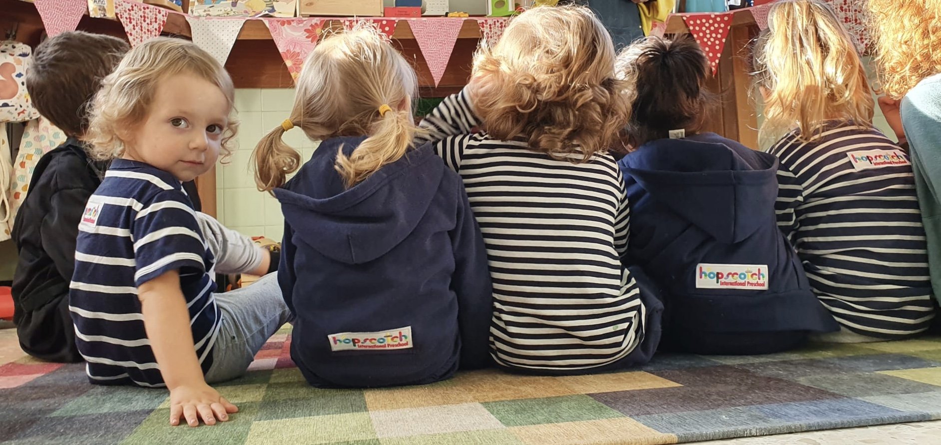 Kids sitting on the floor watching a puppet show