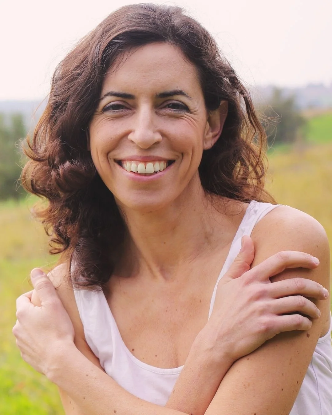 Midlife woman outdoors representing vitality, hormone balance, and long-term health through integrative nutrition