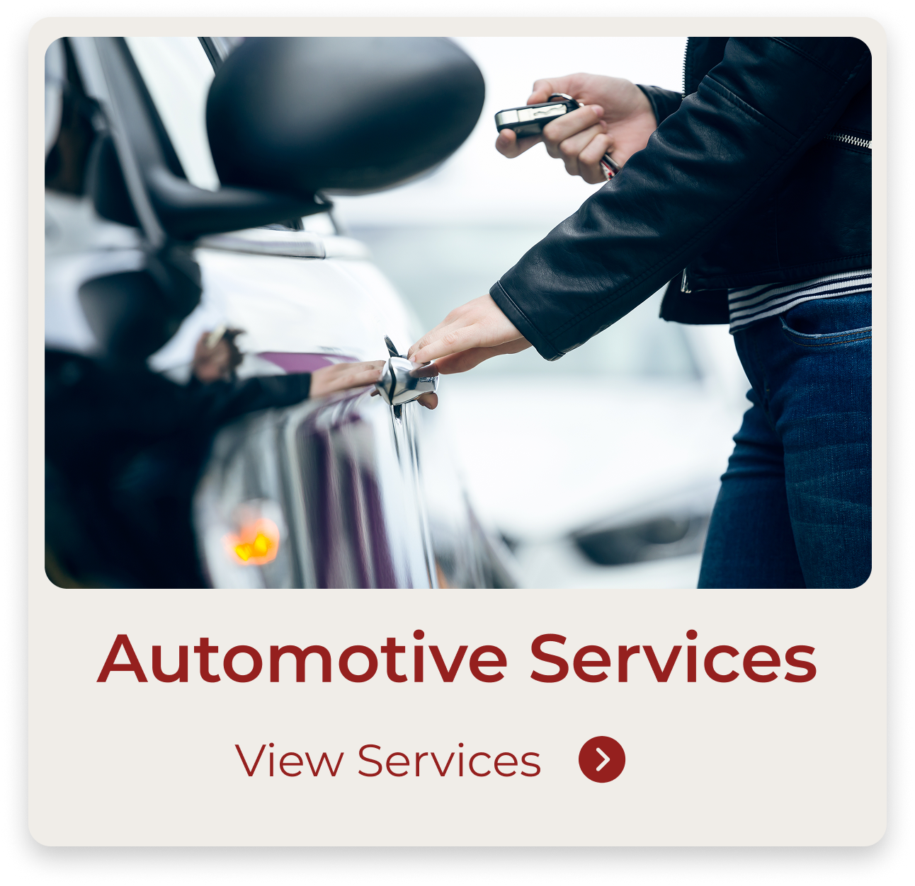 A person in a black leather jacket reaching to open a car door with one hand, holding a remote key in the other hand, in an outdoor setting.