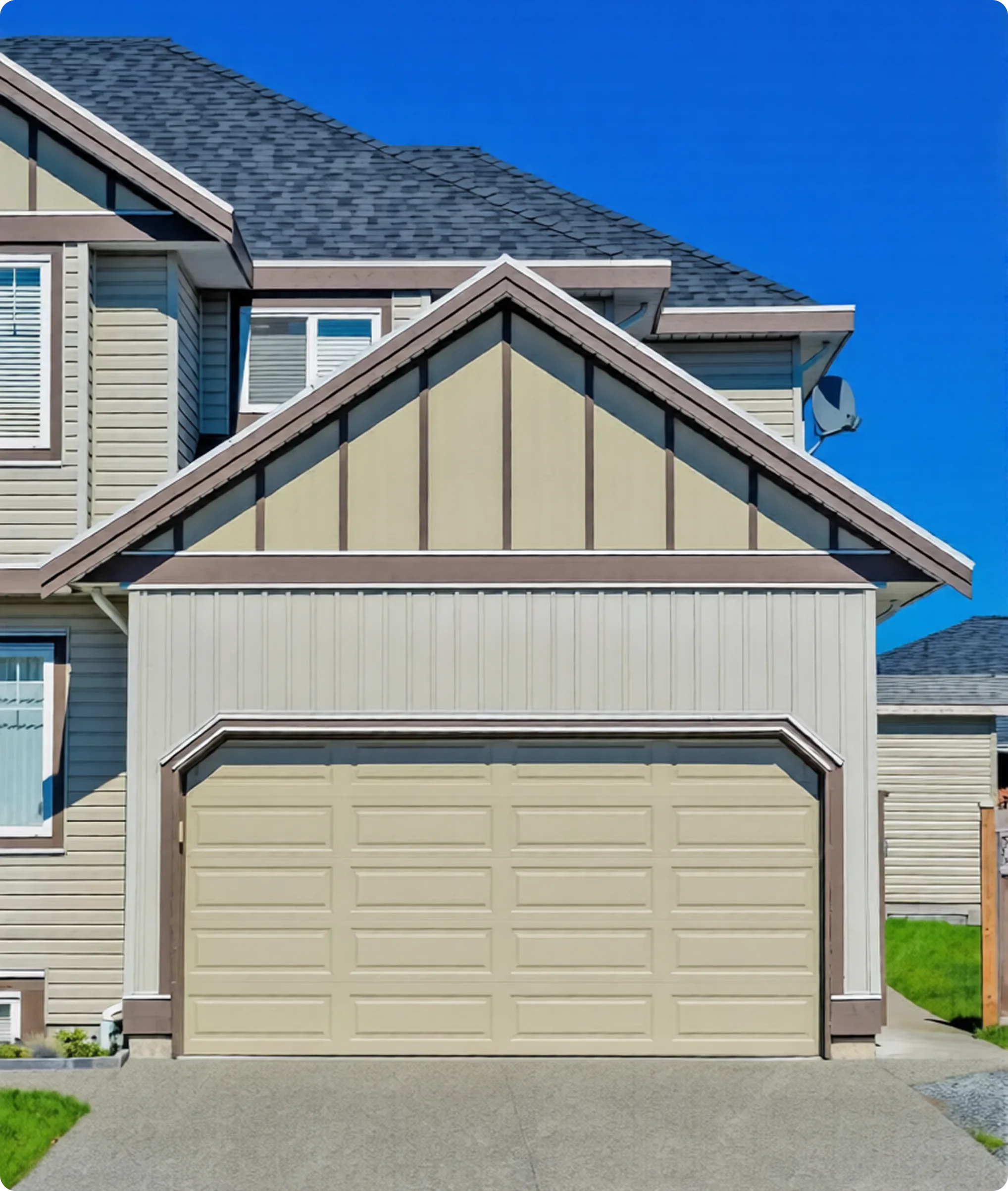 Front view of a beige garage door with a house and blue sky in the background.