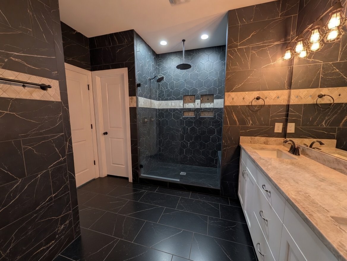 Modern master bath featuring black marble tile and walk-in shower