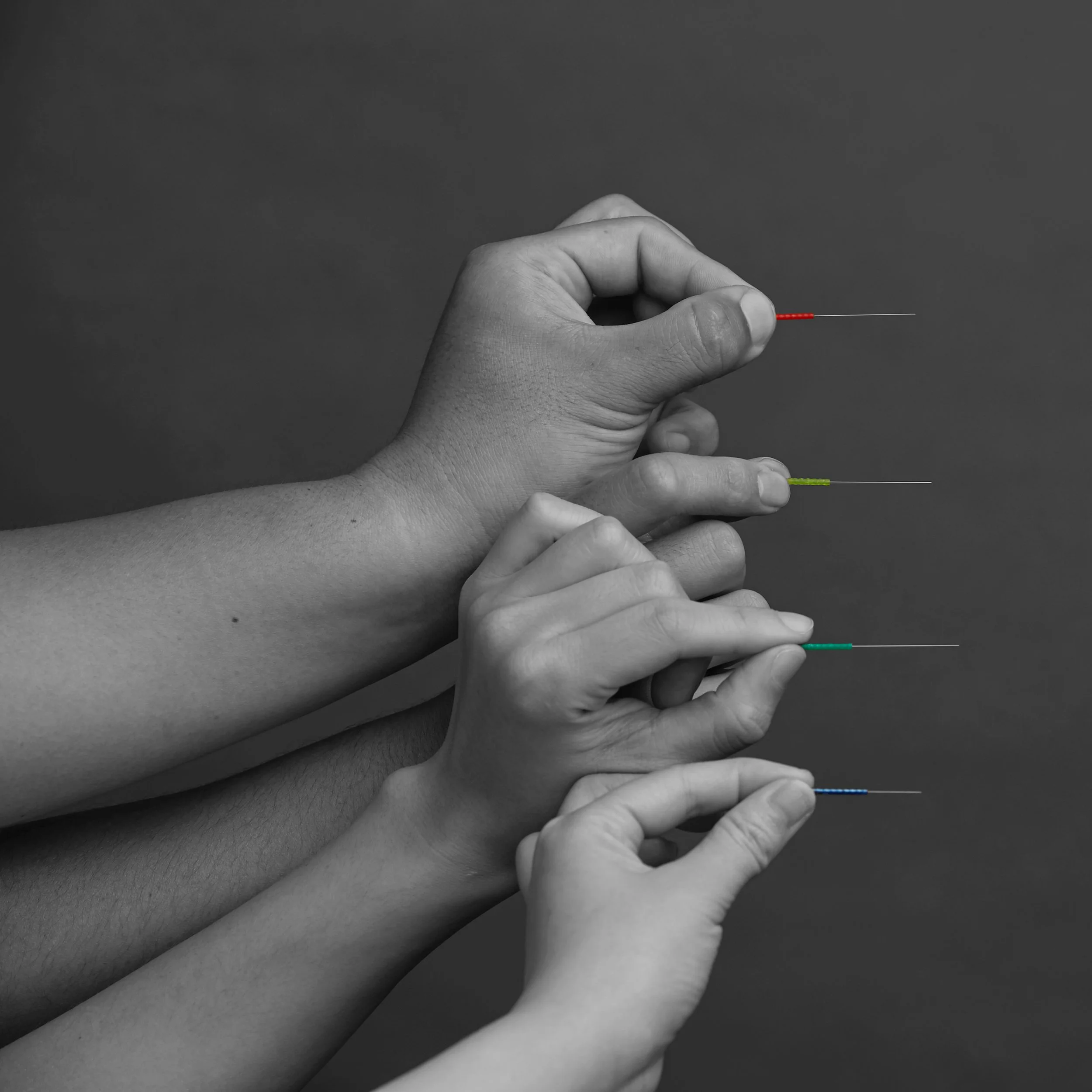 Close-up of hands holding Seirin acupuncture needles