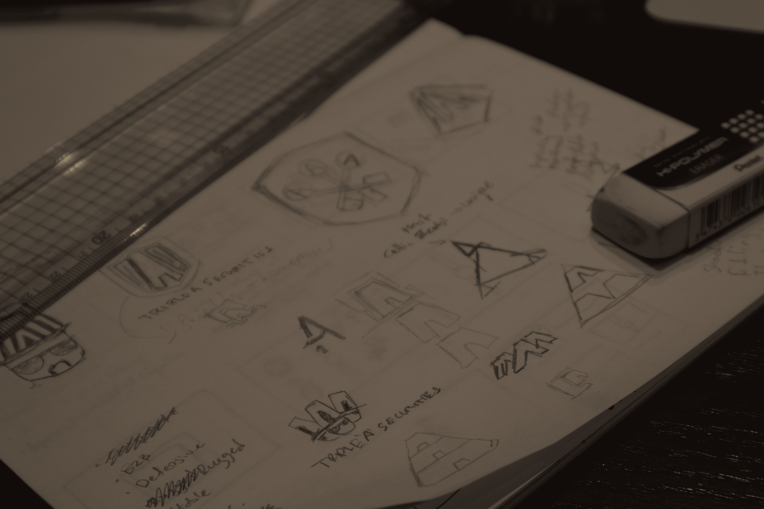 Hand-drawn sketches and notes on a piece of paper, with a ruler and a glue stick nearby.