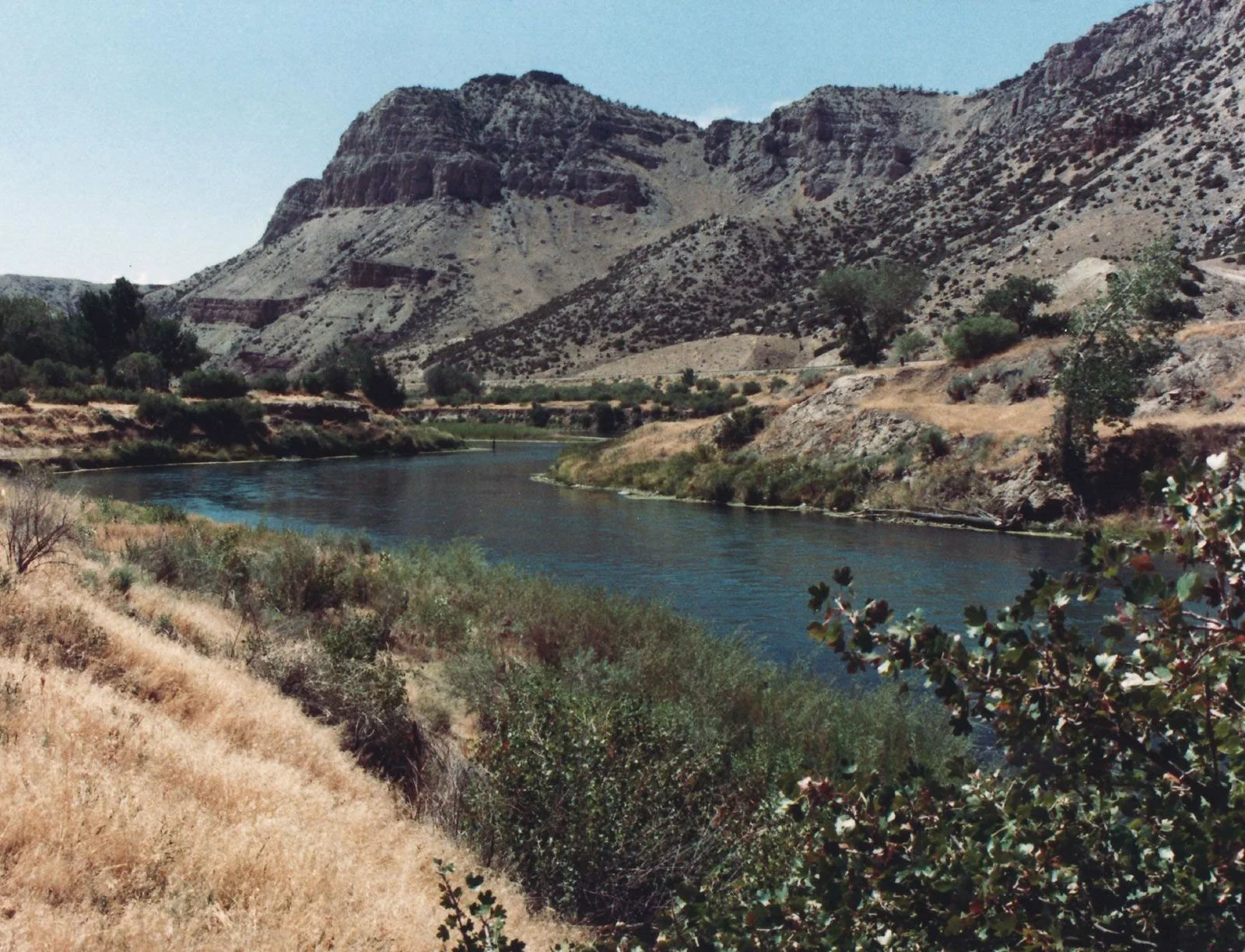 An image of a canyon just outside of Riverton, Wyoming, with a calm river running through.