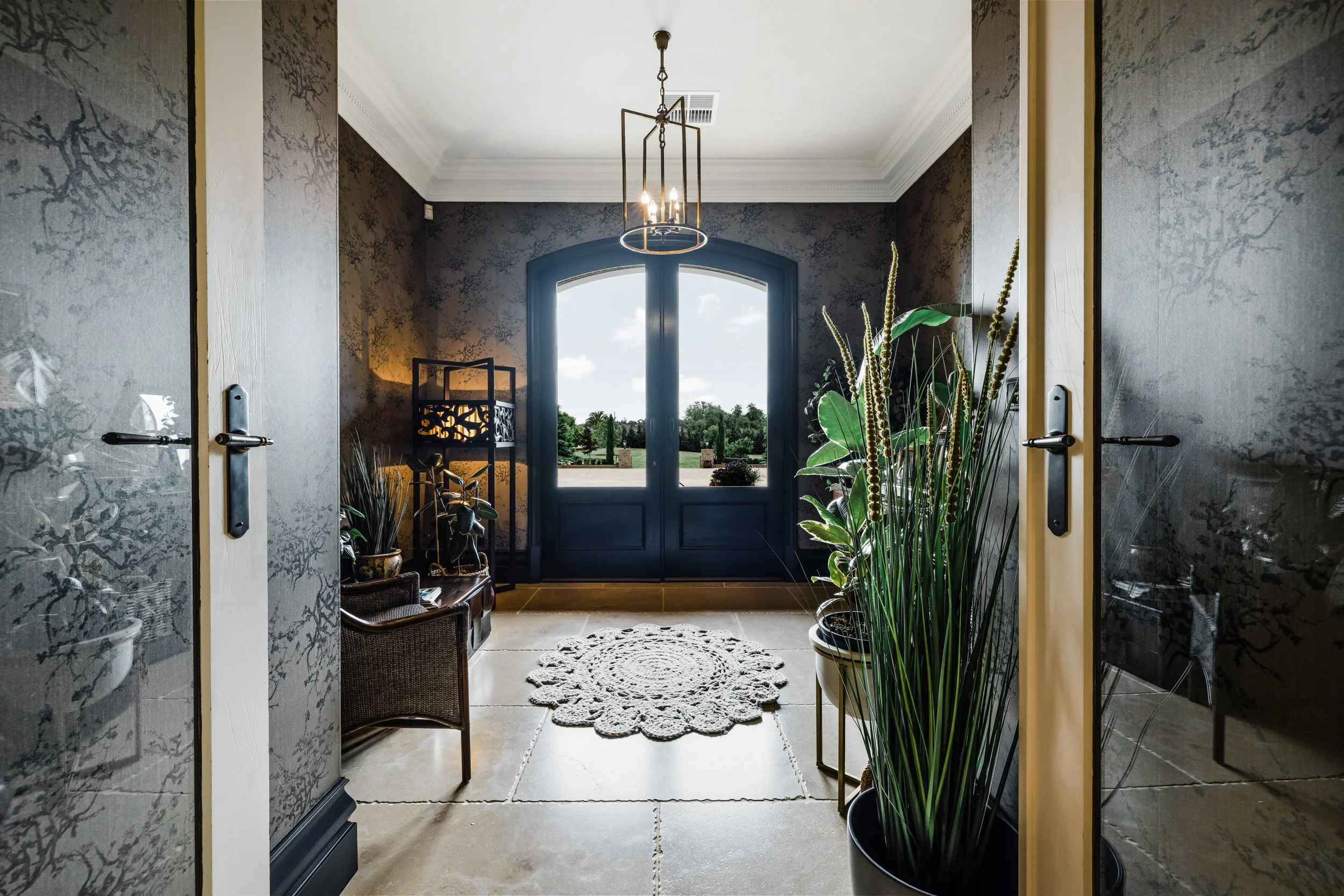 Lime Stone Floors, decorative wallpaper, large double entry doors, indoor plants
