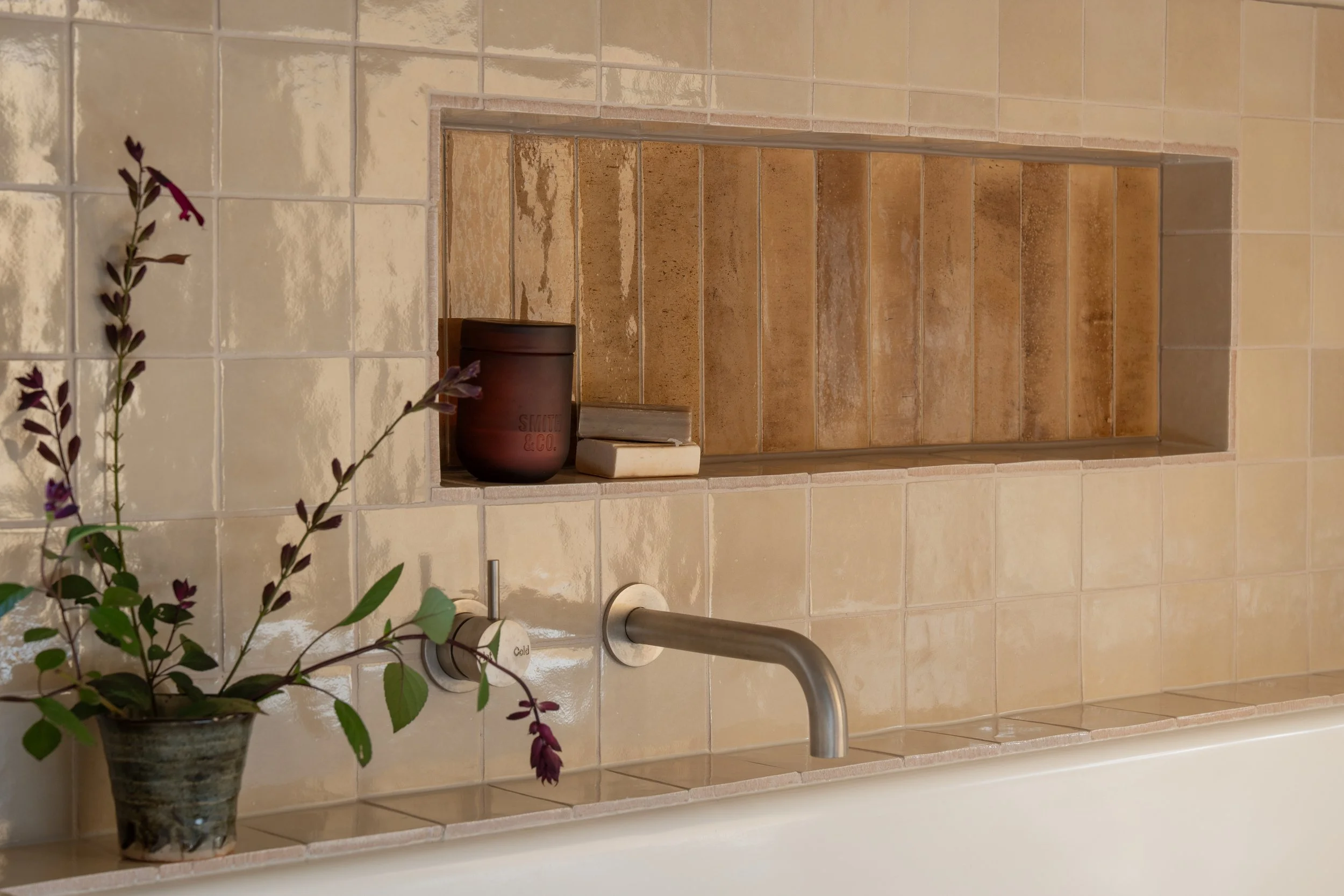 Rustic cream and mustard tiles, bath niche with wall mixer and outlet 