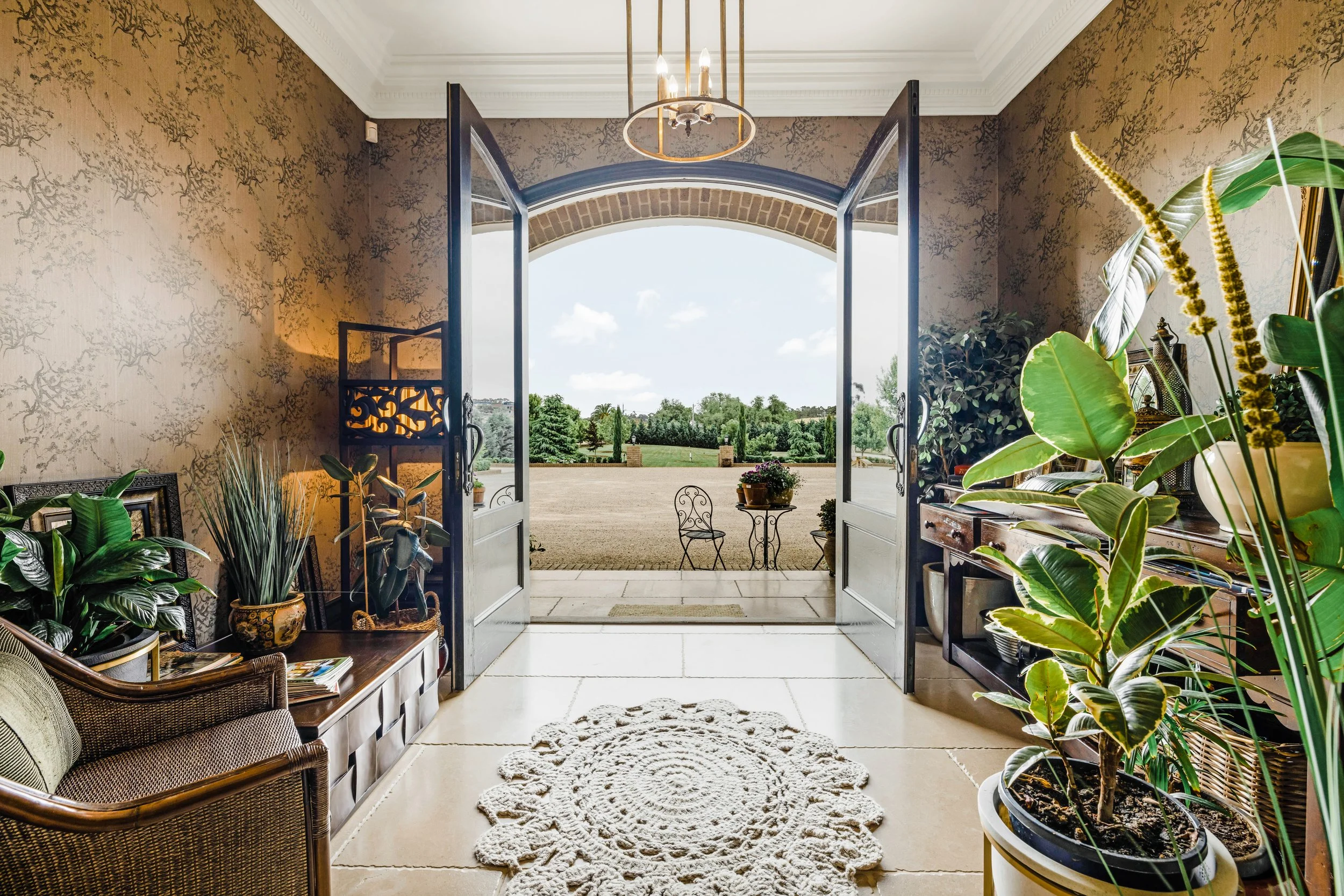 Lime Stone Floors, decorative wallpaper, large double entry doors, indoor plants