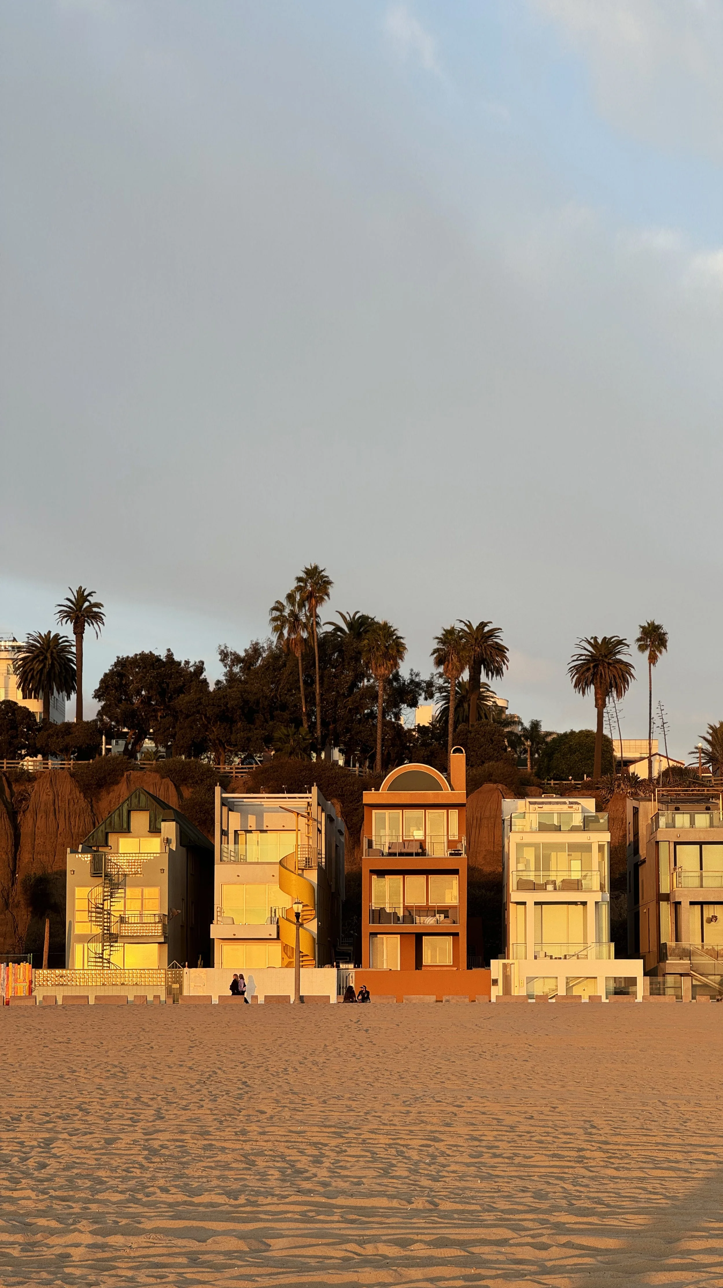 Benjamin Liatoud designs bespoke luxury architecture worldwide. Beachfront houses at sunset with palm trees in the background.