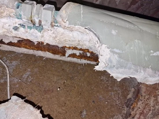 Asbestos thermal insulation on pipework within a building service area
