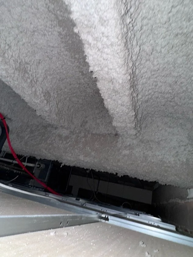 Confirmed asbestos sprayed coating applied to the underside of a ceiling