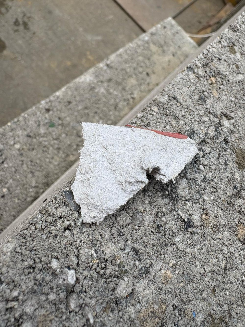 Asbestos insulating board debris requiring a recorded management response