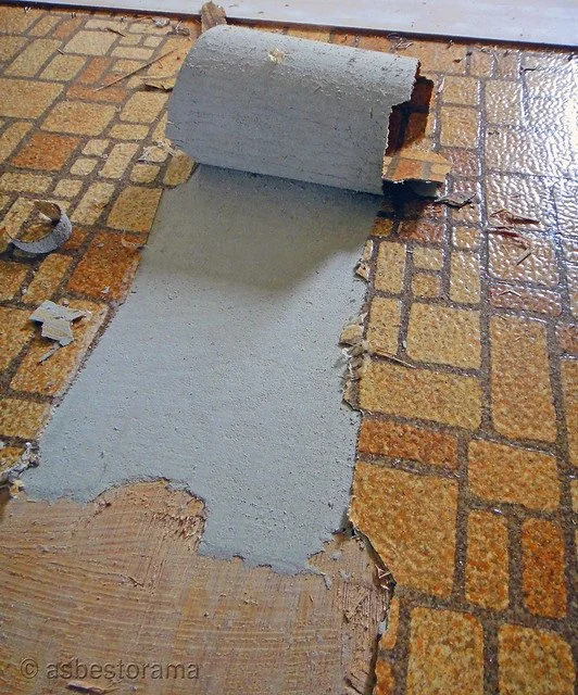 Asbestos paper backing to flooring