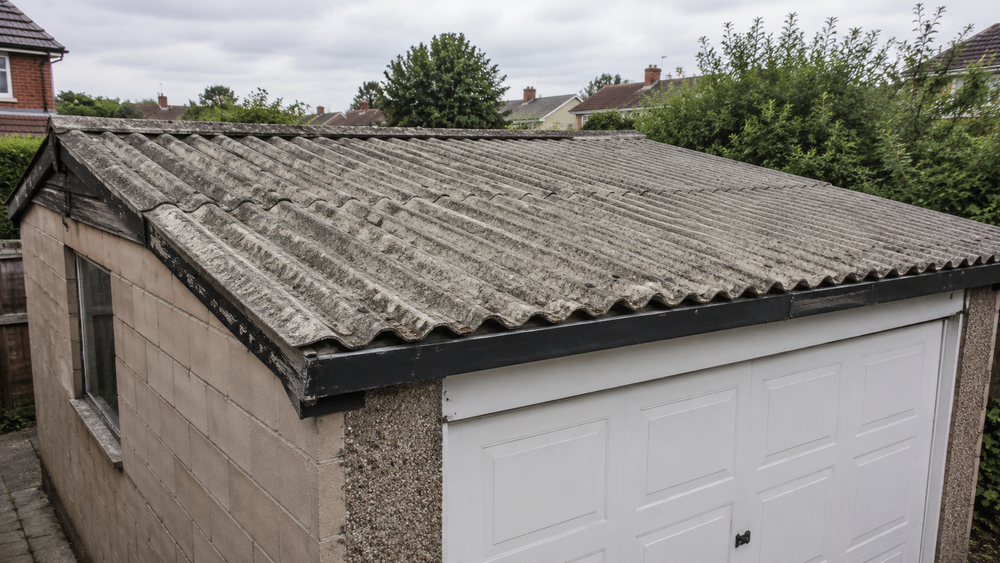 Domestic garage with an asbestos cement roof before controlled removal