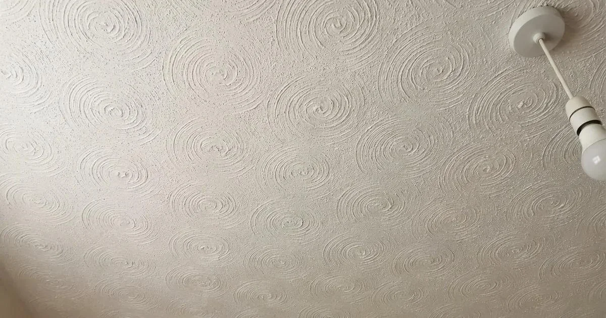 White textured Artex ceiling in a UK home showing a swirl pattern, used for an asbestos testing and removal guide.