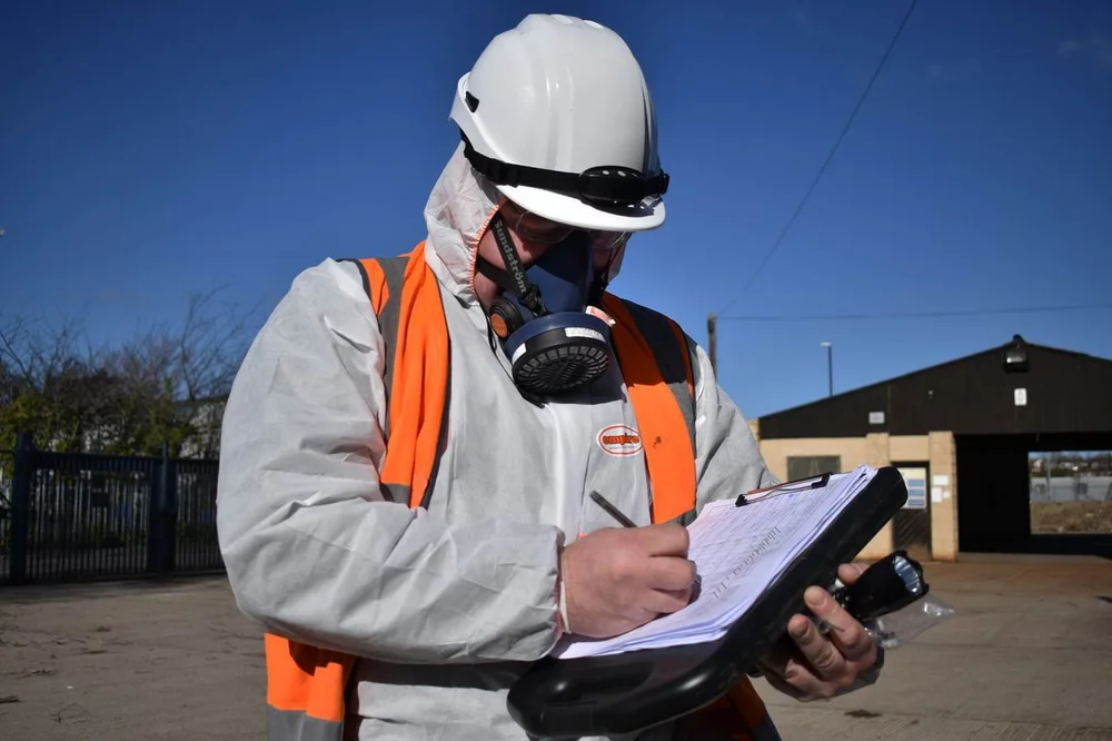 ASM asbestos analyst preparing air-monitoring equipment