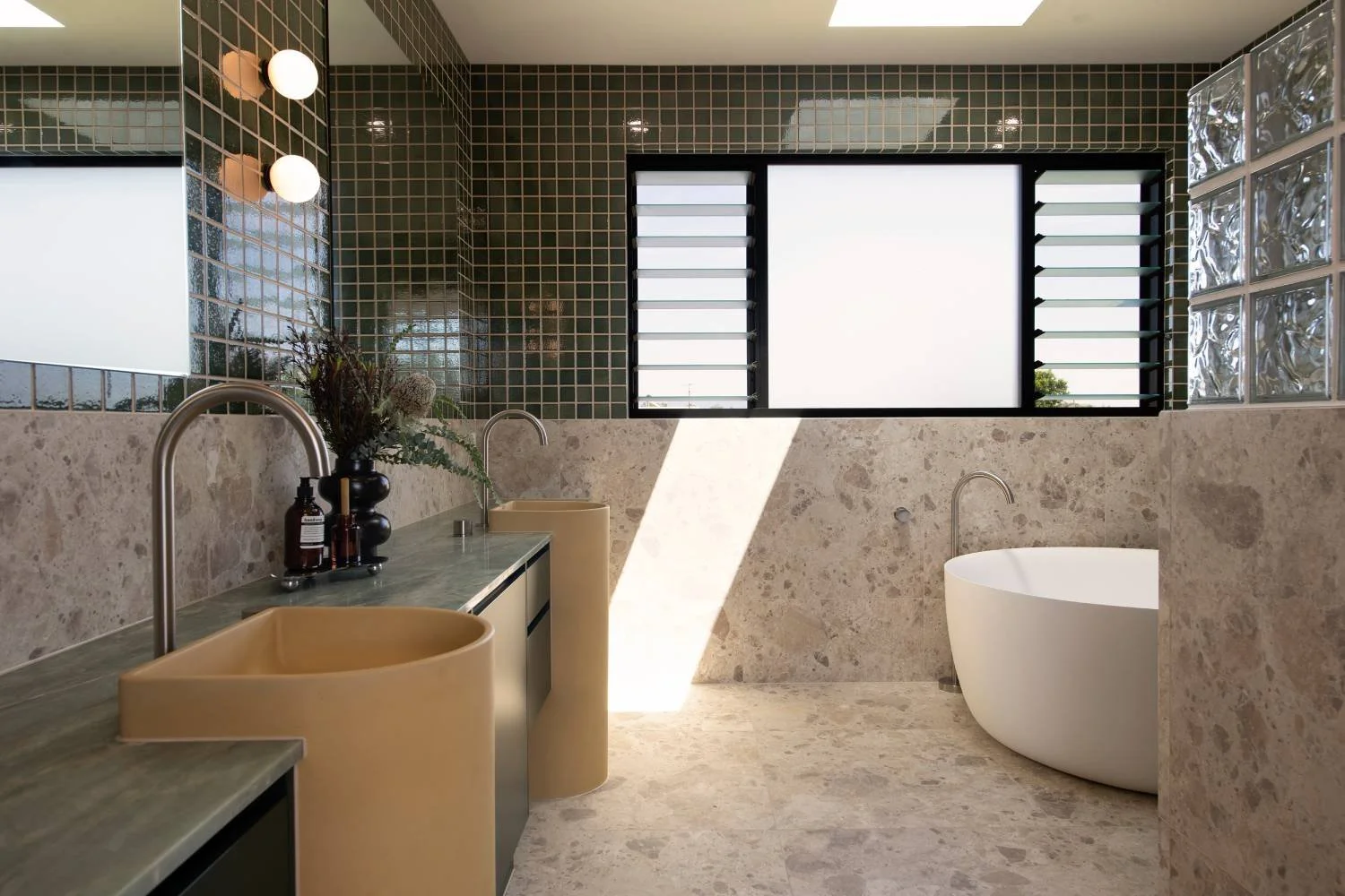 Modern bathroom with stone finishes and natural light