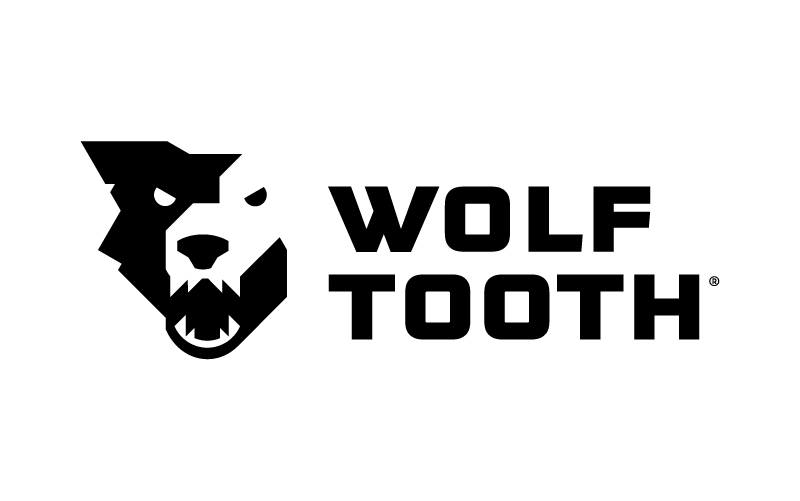 A black and white logo with a stylized wolf's head next to the text 'WOLF TOOTH' in bold capital letters.