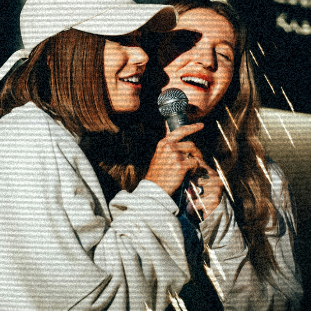 Two women absolutely belting out their favourite karaoke banger in one of the stunning Karaoke rooms at The Lucky Goat. 