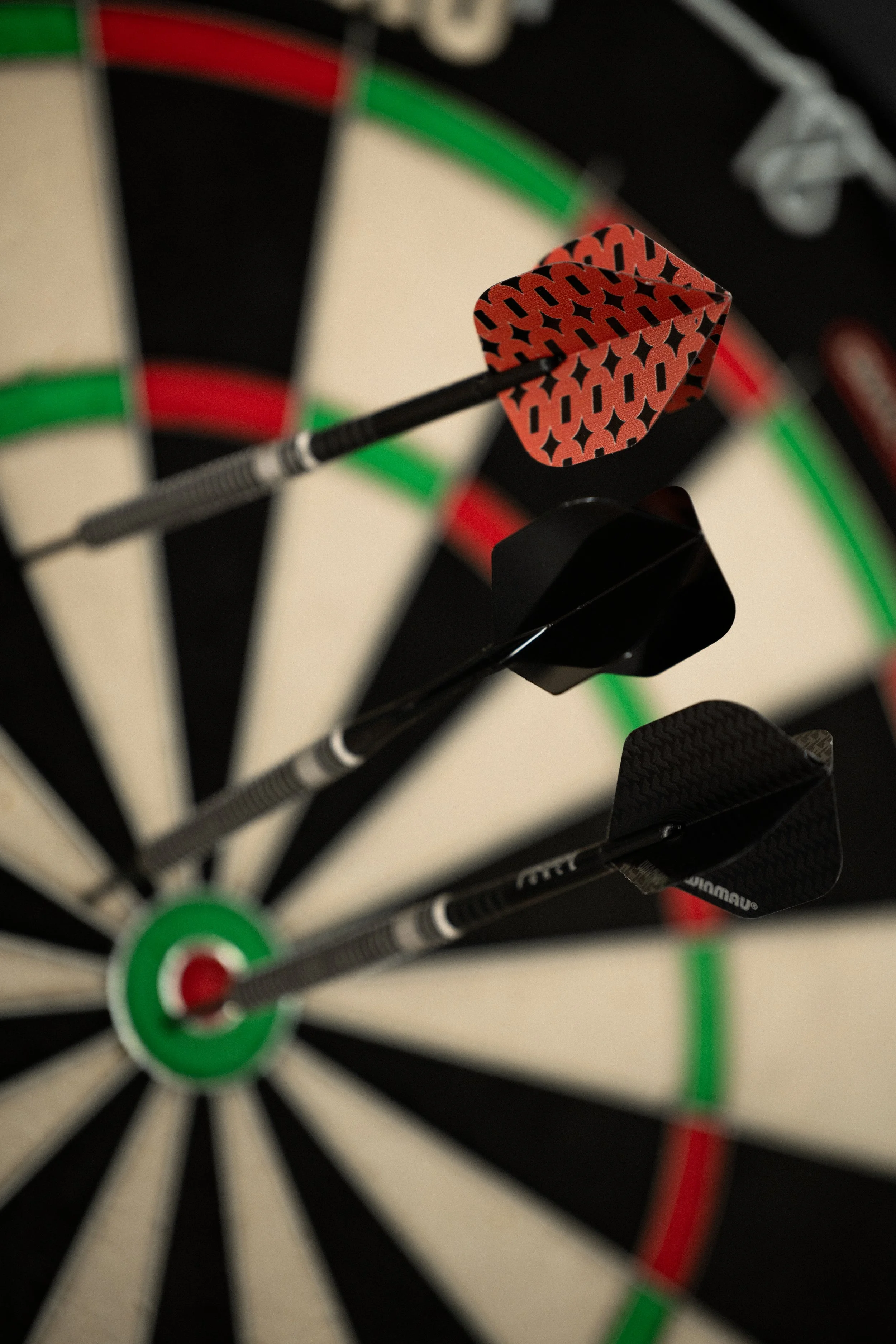 A person playing darts on one of The Lucky Goats epic tech dartboards. They probably just scored a bullseye. So I'm afraid it's your round.
