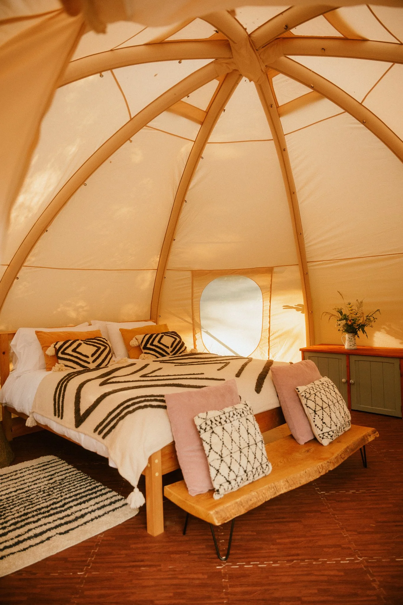 Kingsize bed featured inside a spacious canvas dome tent 