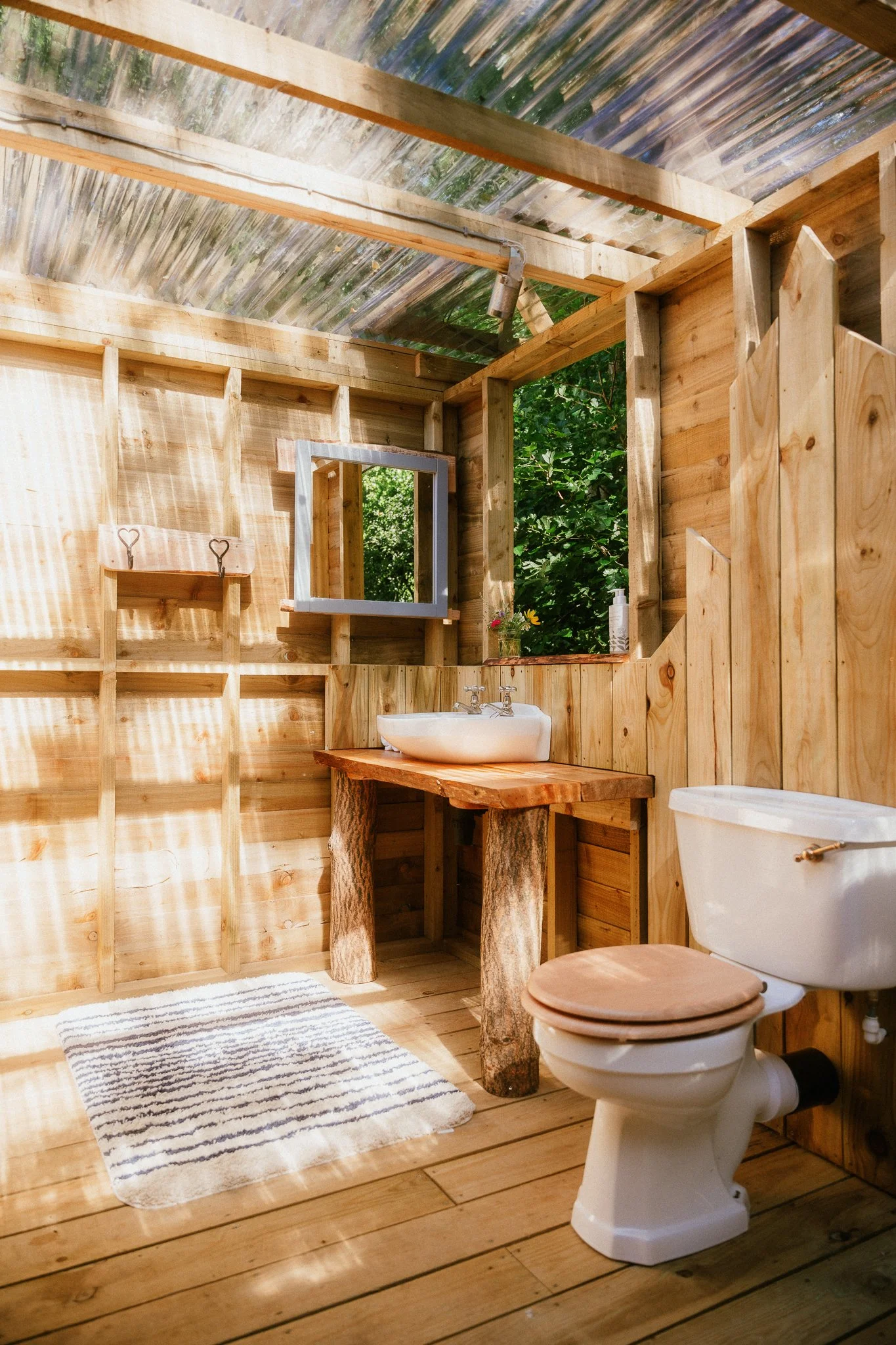 Luxury wooden camping bathroom with flushing toilet and hot and cold running water 