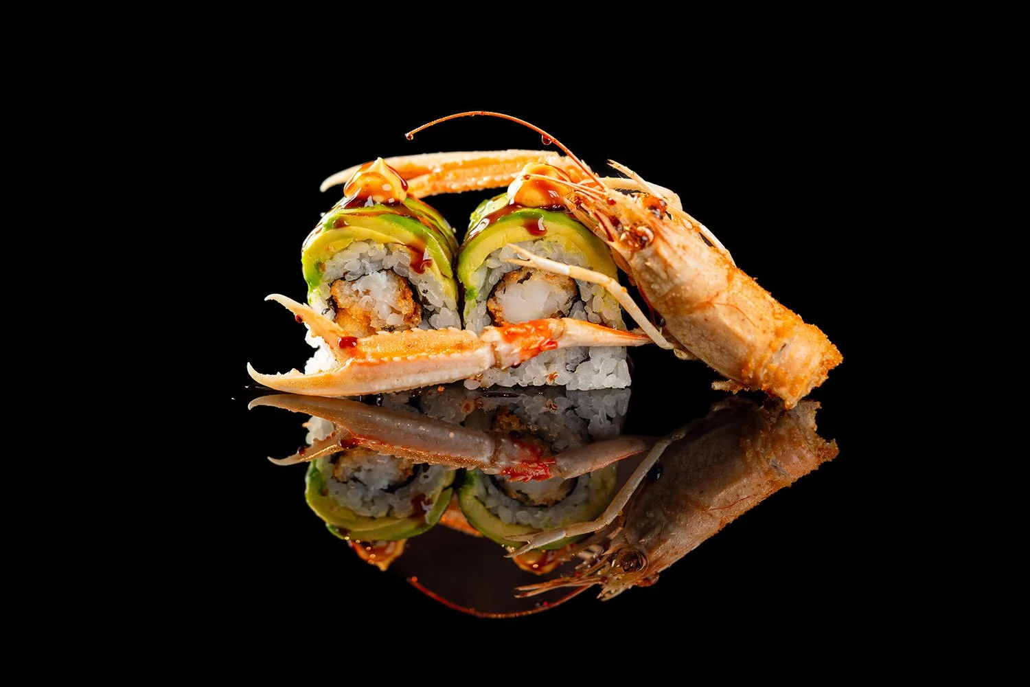Sushi mit Lachs, Avocado und Garnelen auf schwarzem Hintergrund mit Reflexion