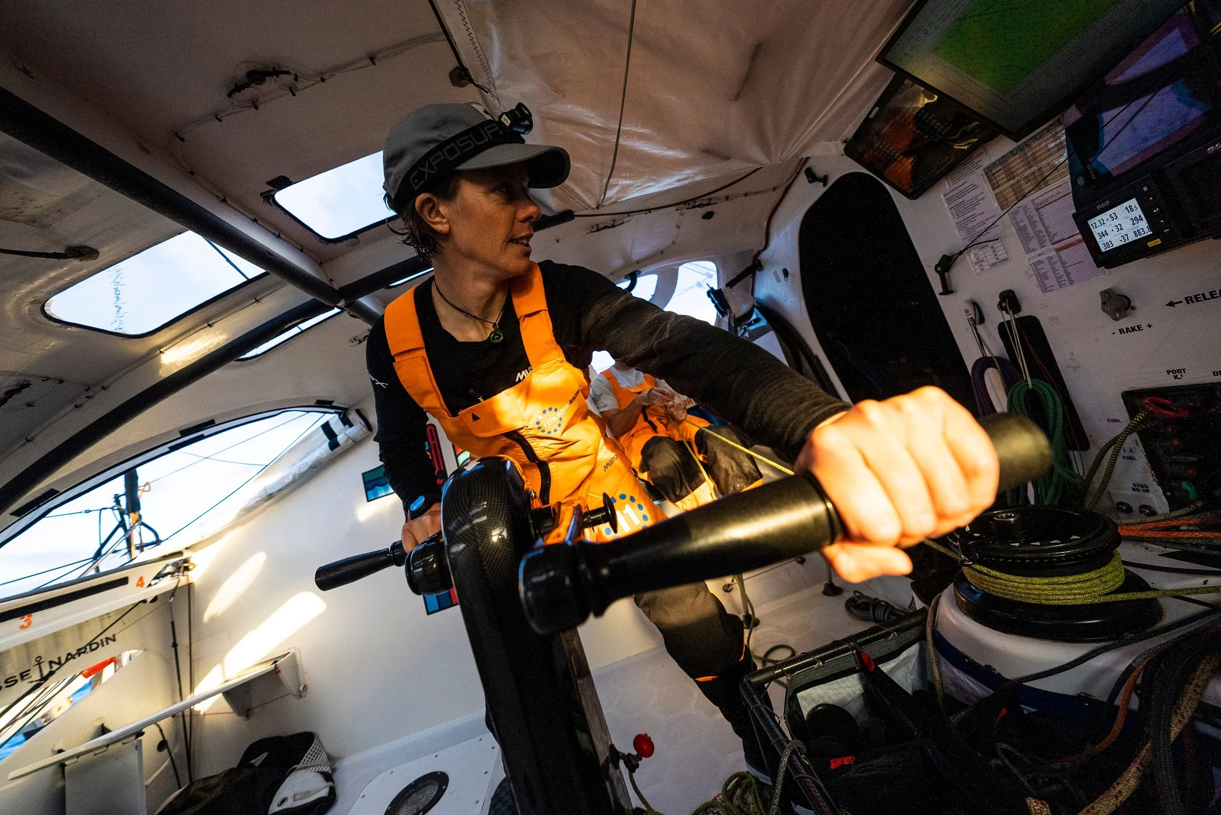 Francesca onboard a racing yacht grinding at the pedestal