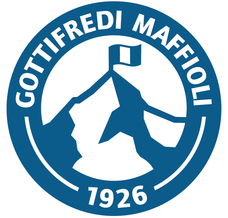 A circular logo with the text "GOTTIFREDI MELOI" and the year "1926". The center features a stylized figure holding a flag and a sword, with a mountain or peak outline in the background.