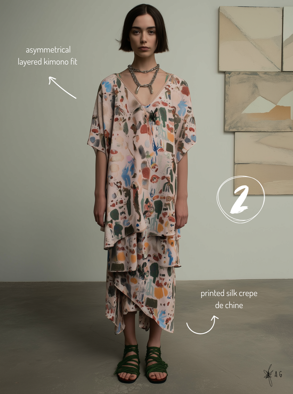 A woman in a layered, printed silk crepe de chine kimono and matching skirt, standing indoors against a neutral background with abstract art on the wall.