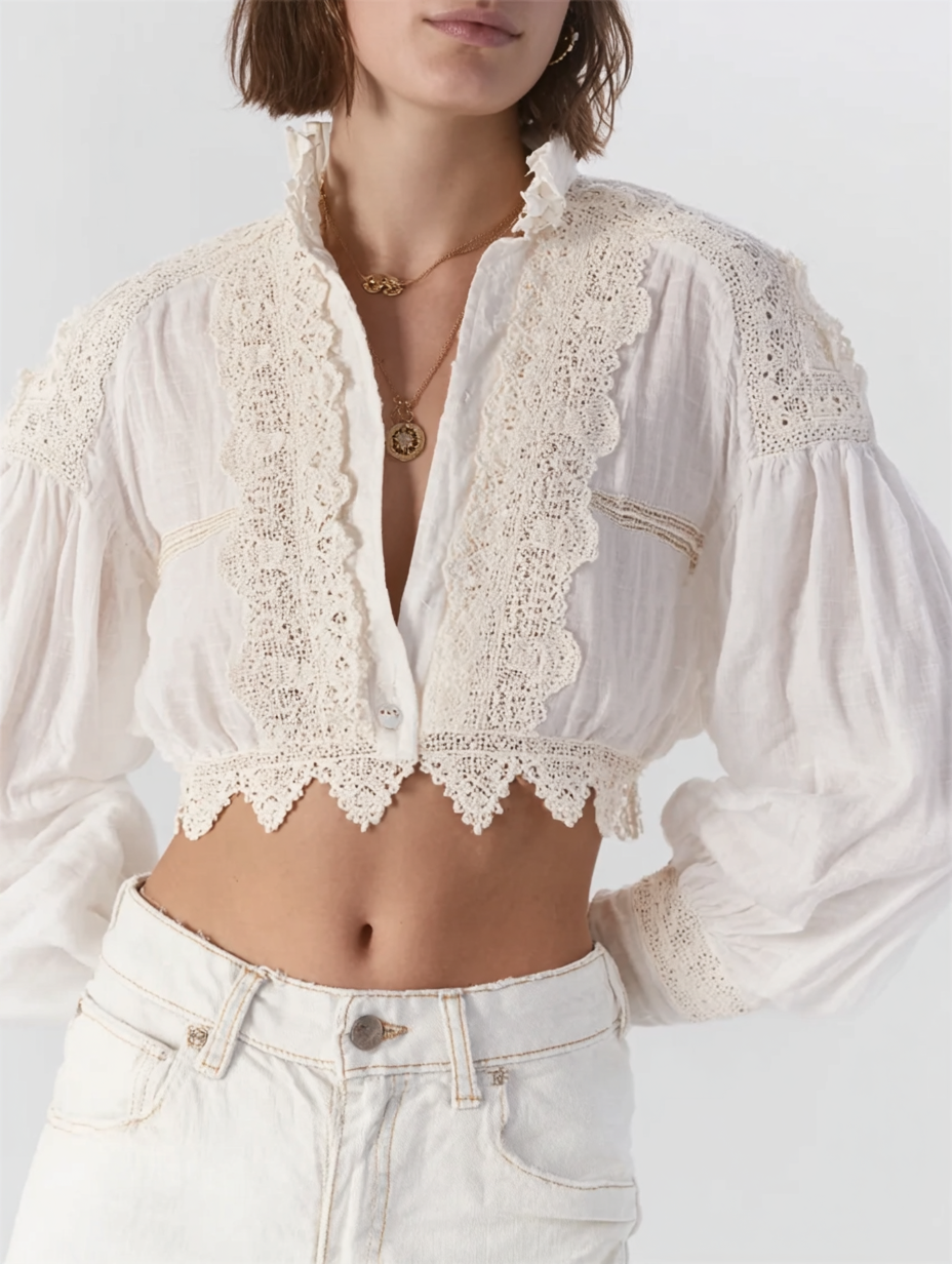 Woman wearing a white, long-sleeve, button-up blouse with lace and crochet details and high-waisted white jeans