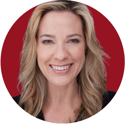 A woman with long blonde hair smiling against a red background.